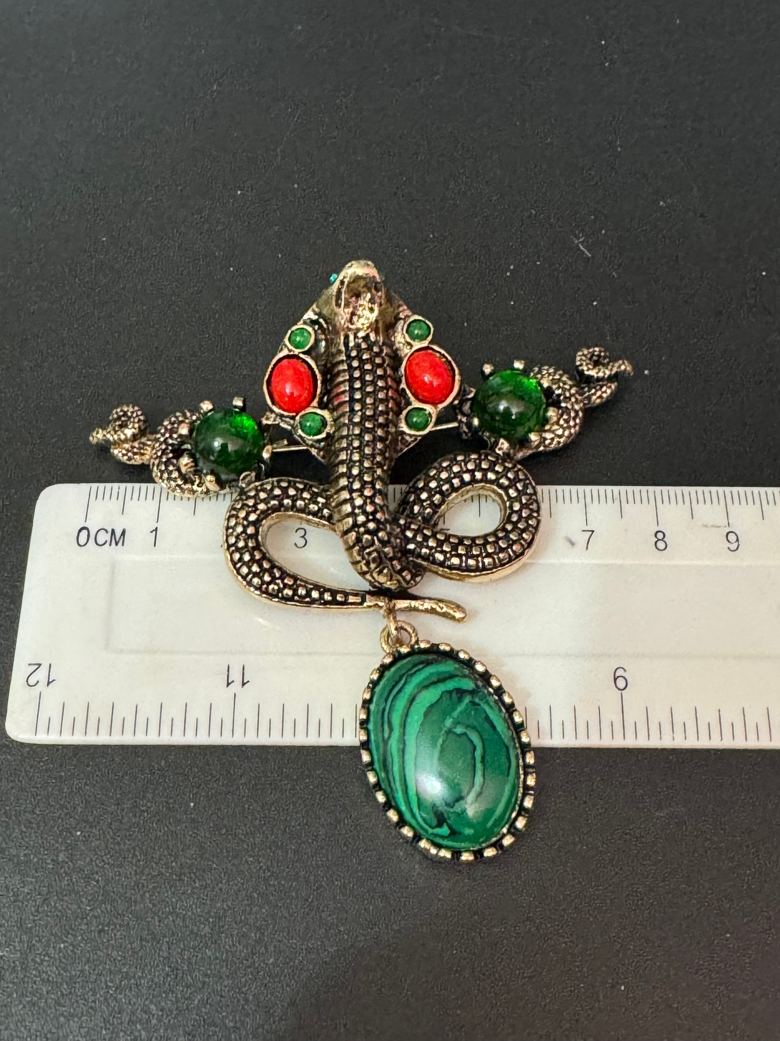 Oversized gold snake brooch with dropper and gemstones