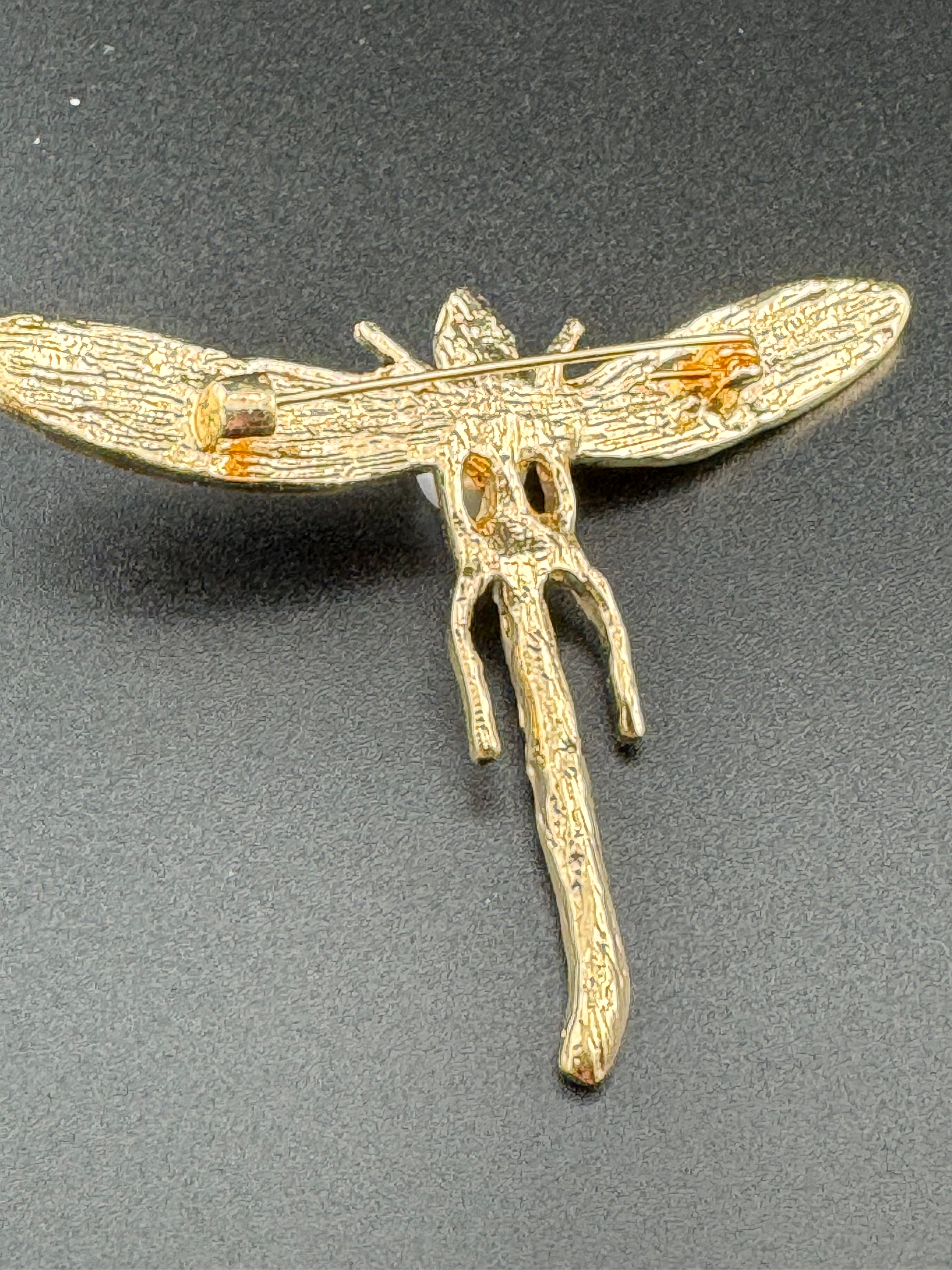 Gold dragonfly brooch set with a peal and green rhinestones