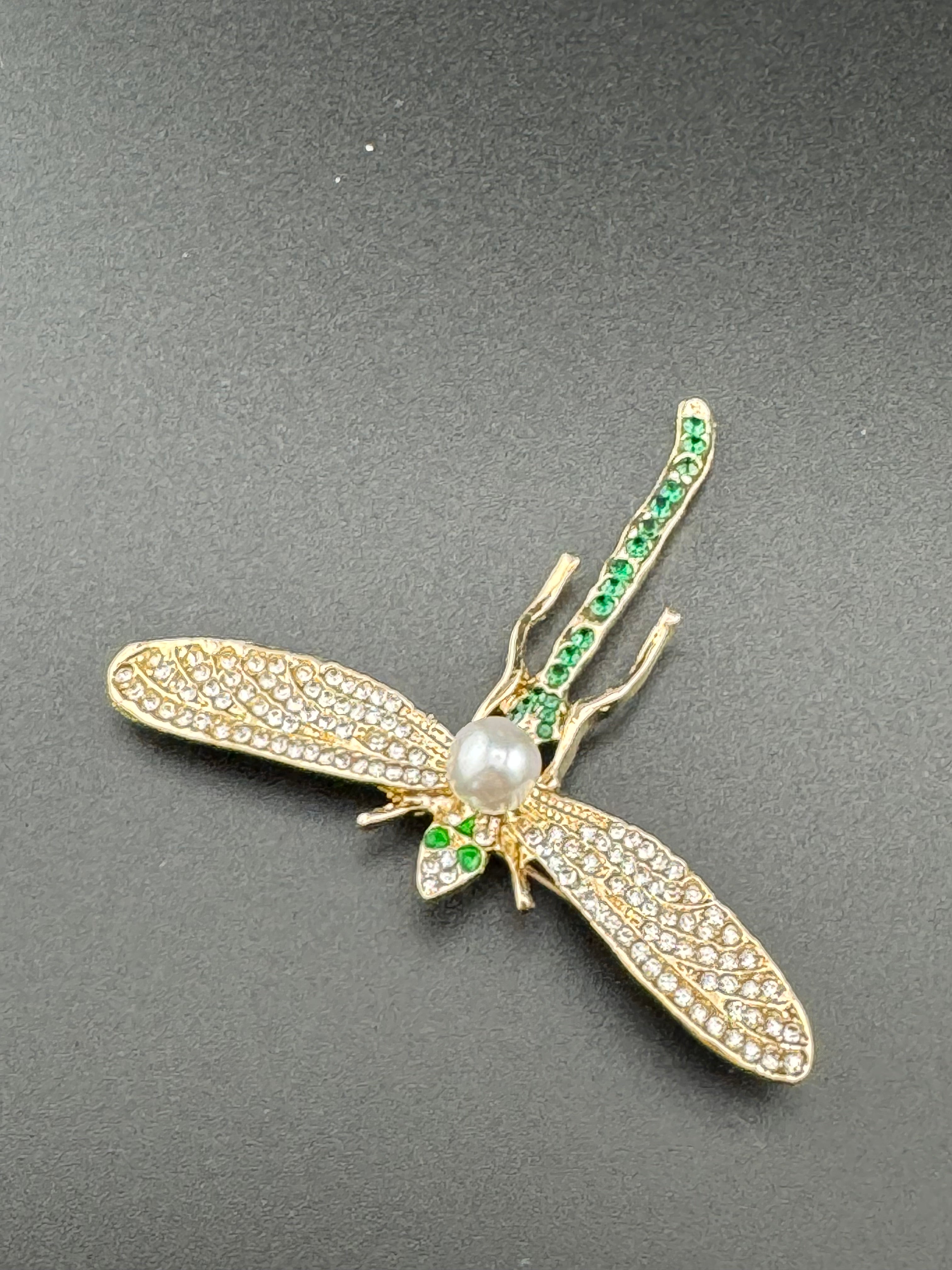 Gold dragonfly brooch set with a peal and green rhinestones