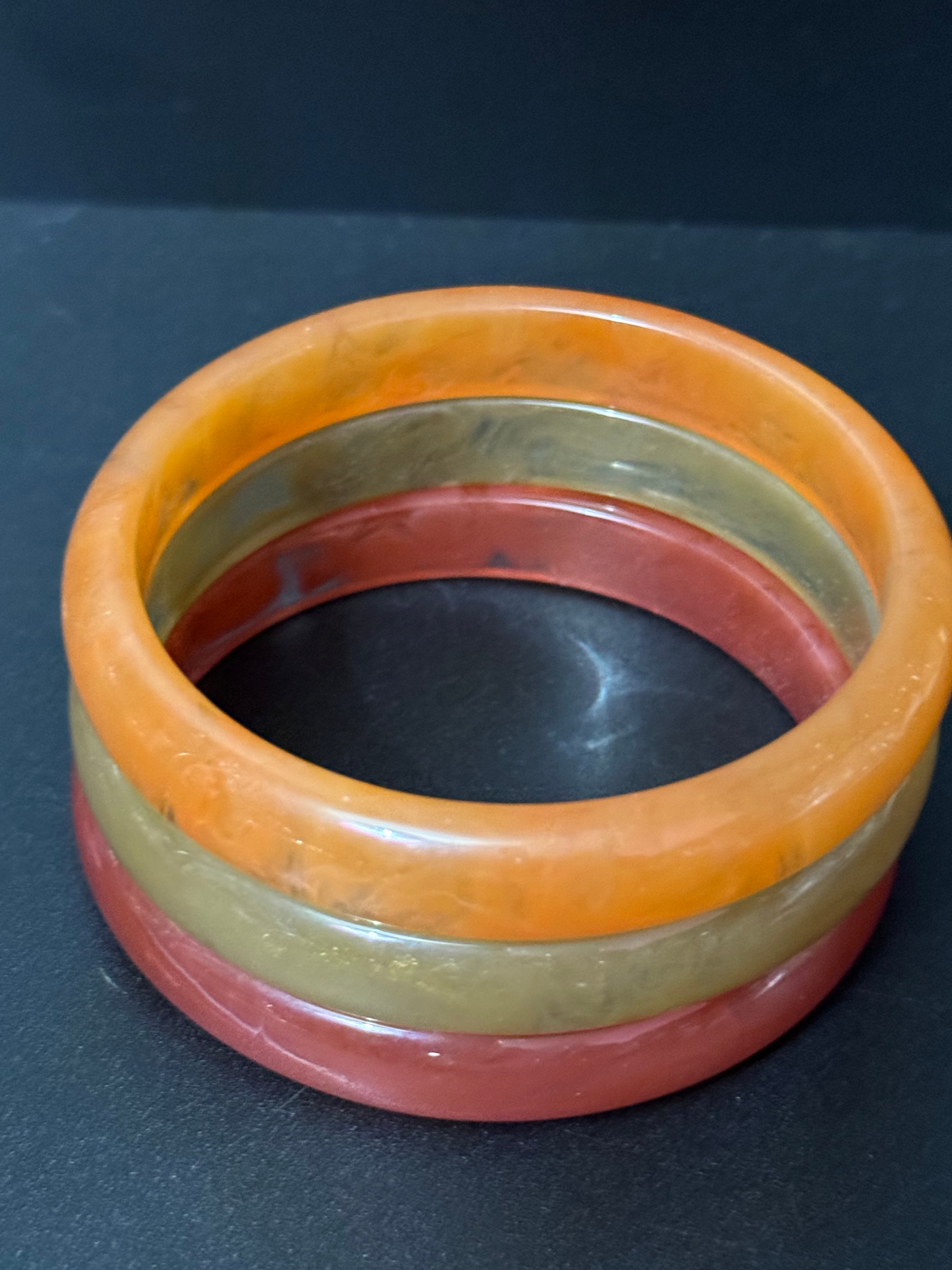 A trio of either orange or green tones mix and match acrylic bangles