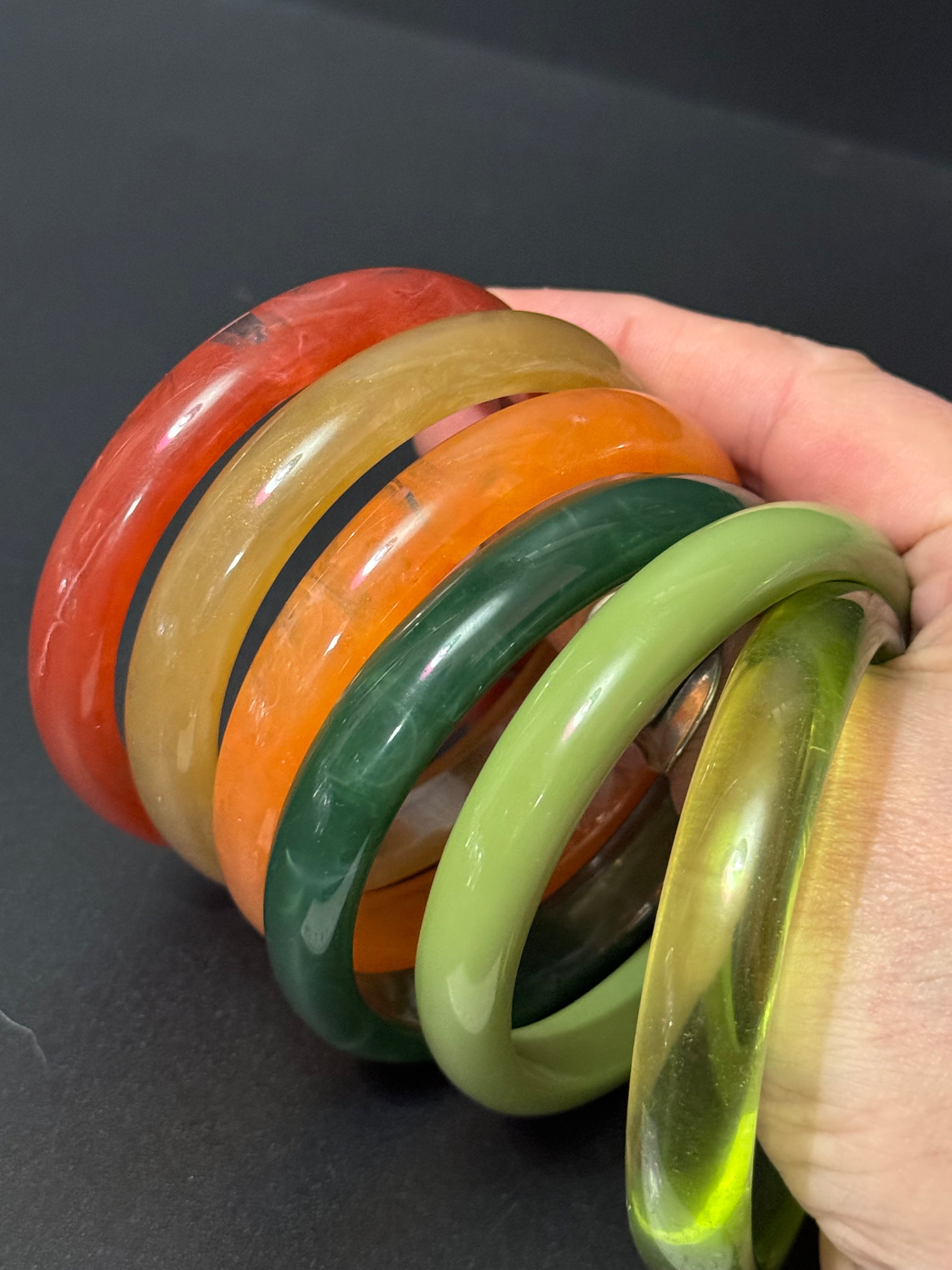 A trio of either orange or green tones mix and match acrylic bangles
