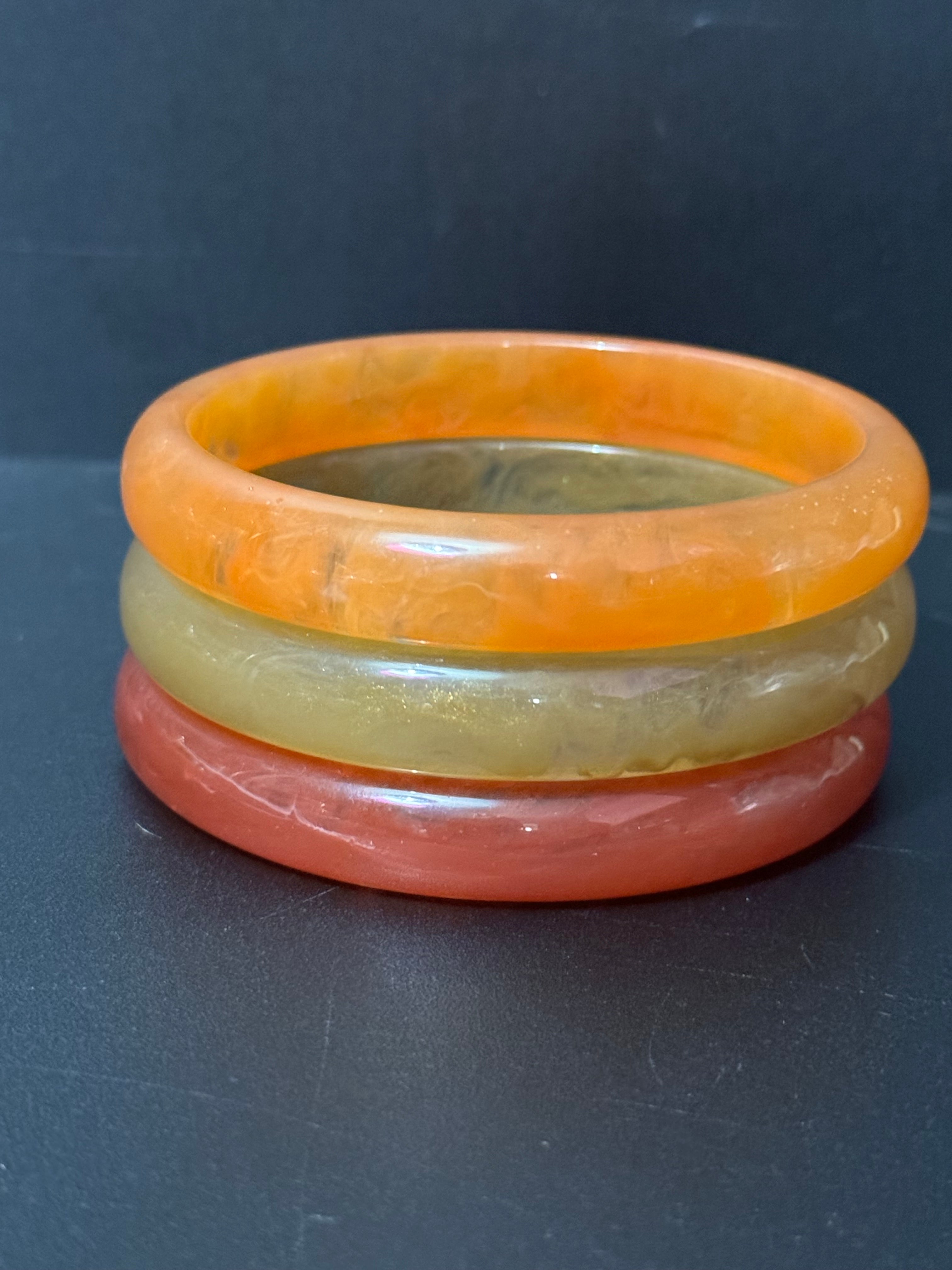 A trio of either orange or green tones mix and match acrylic bangles