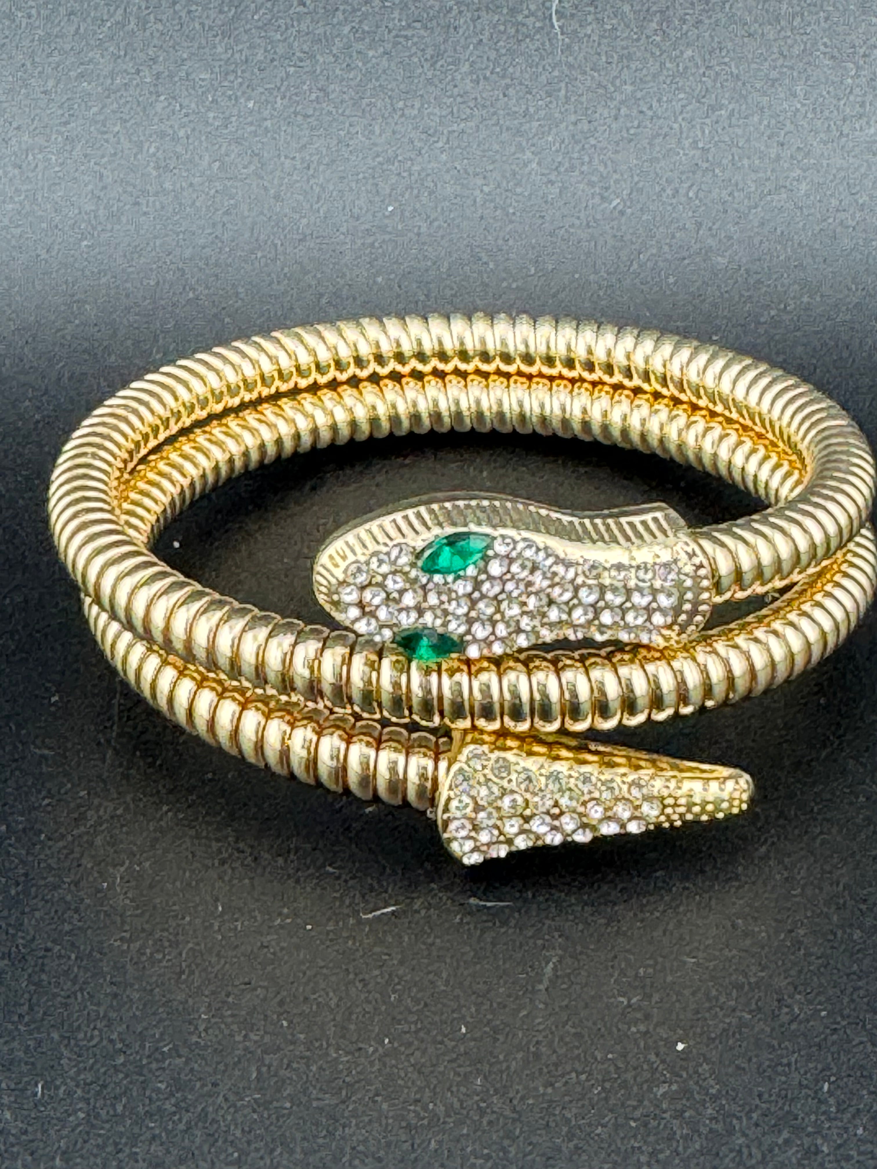 Gold crystal bendy wrap around omega snake bracelet with emerald eyes