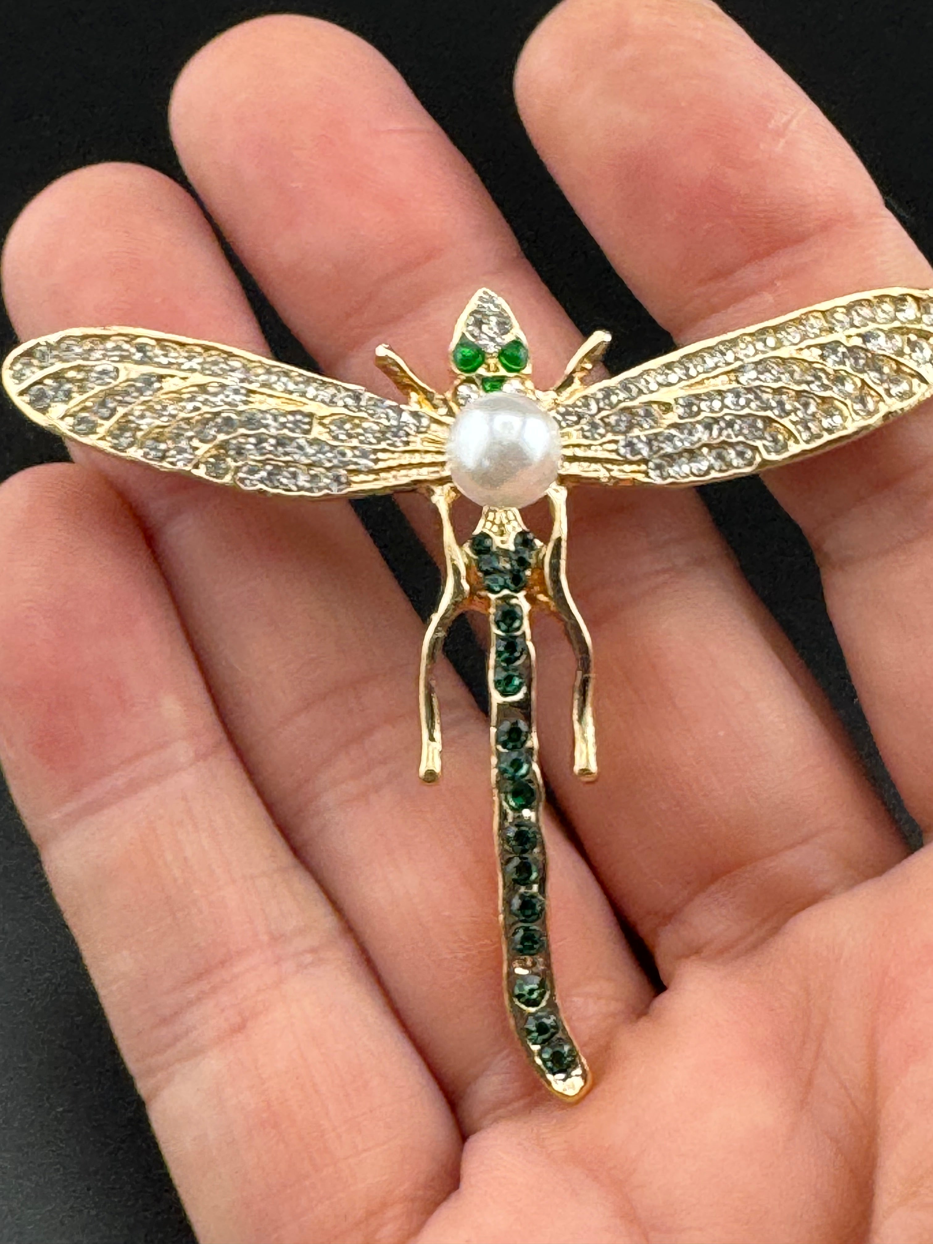 Gold dragonfly brooch set with a peal and green rhinestones