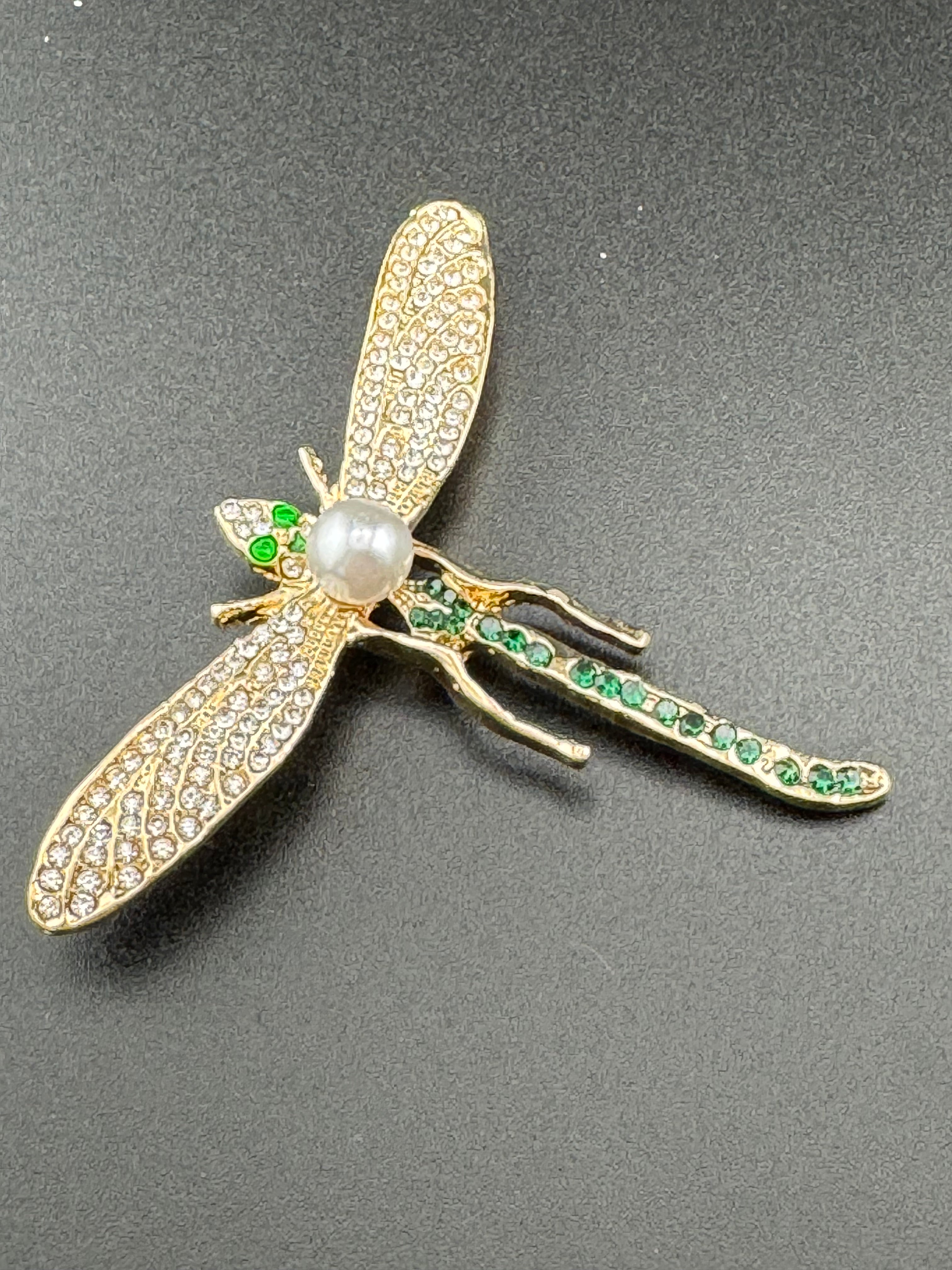 Gold dragonfly brooch set with a peal and green rhinestones