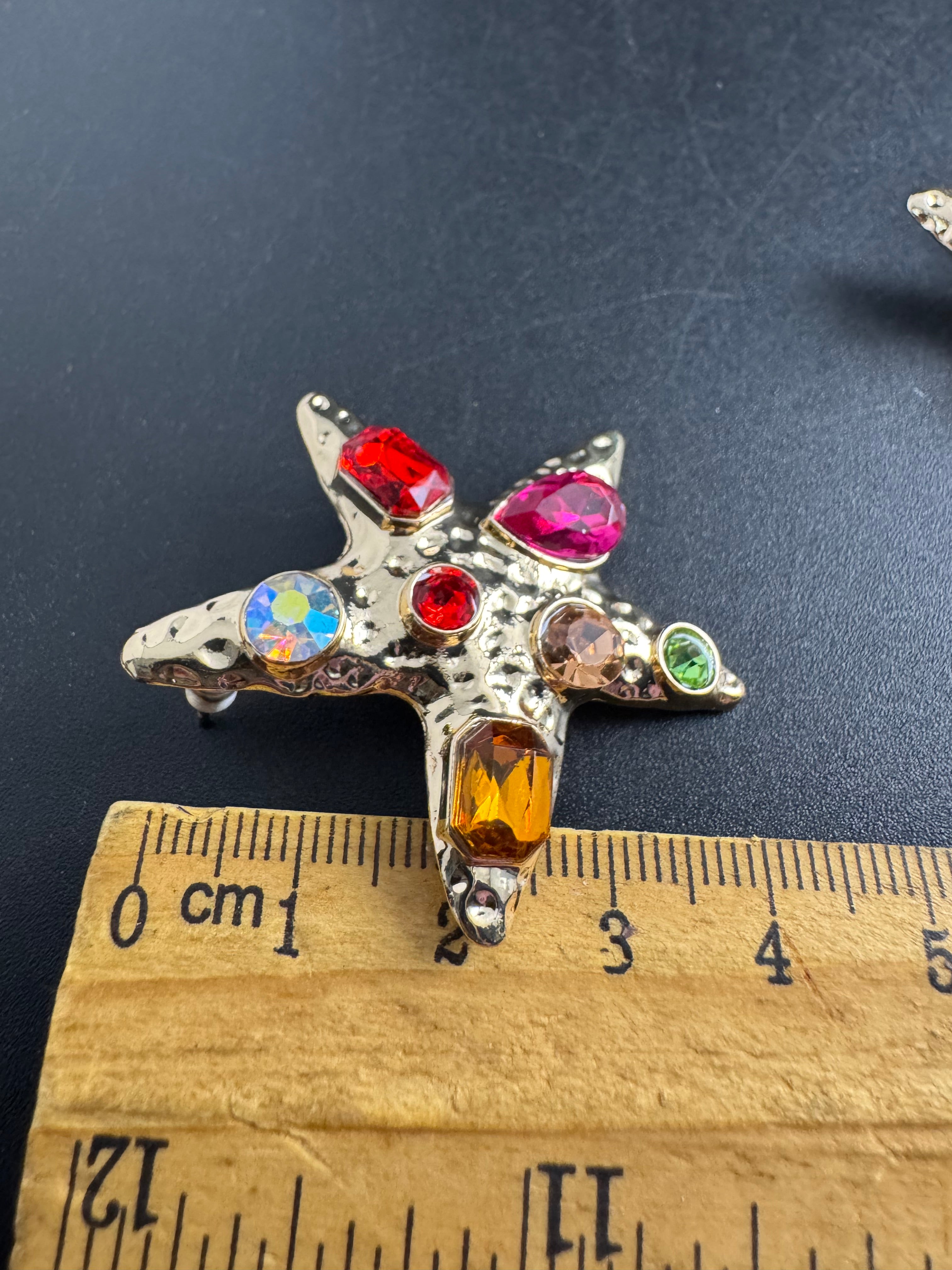 Oversized gold starfish earrings set with rainbow crystals, nautical jewellery