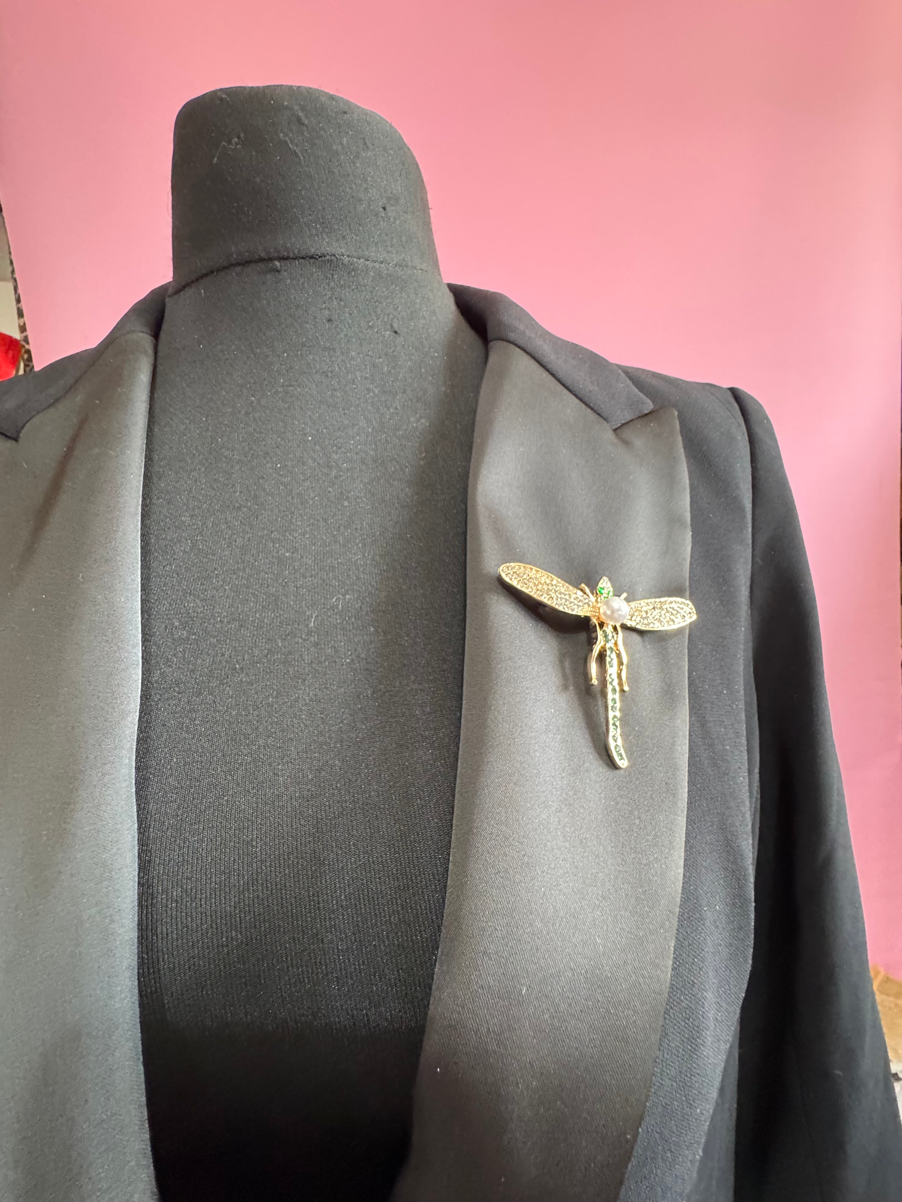 Gold dragonfly brooch set with a peal and green rhinestones
