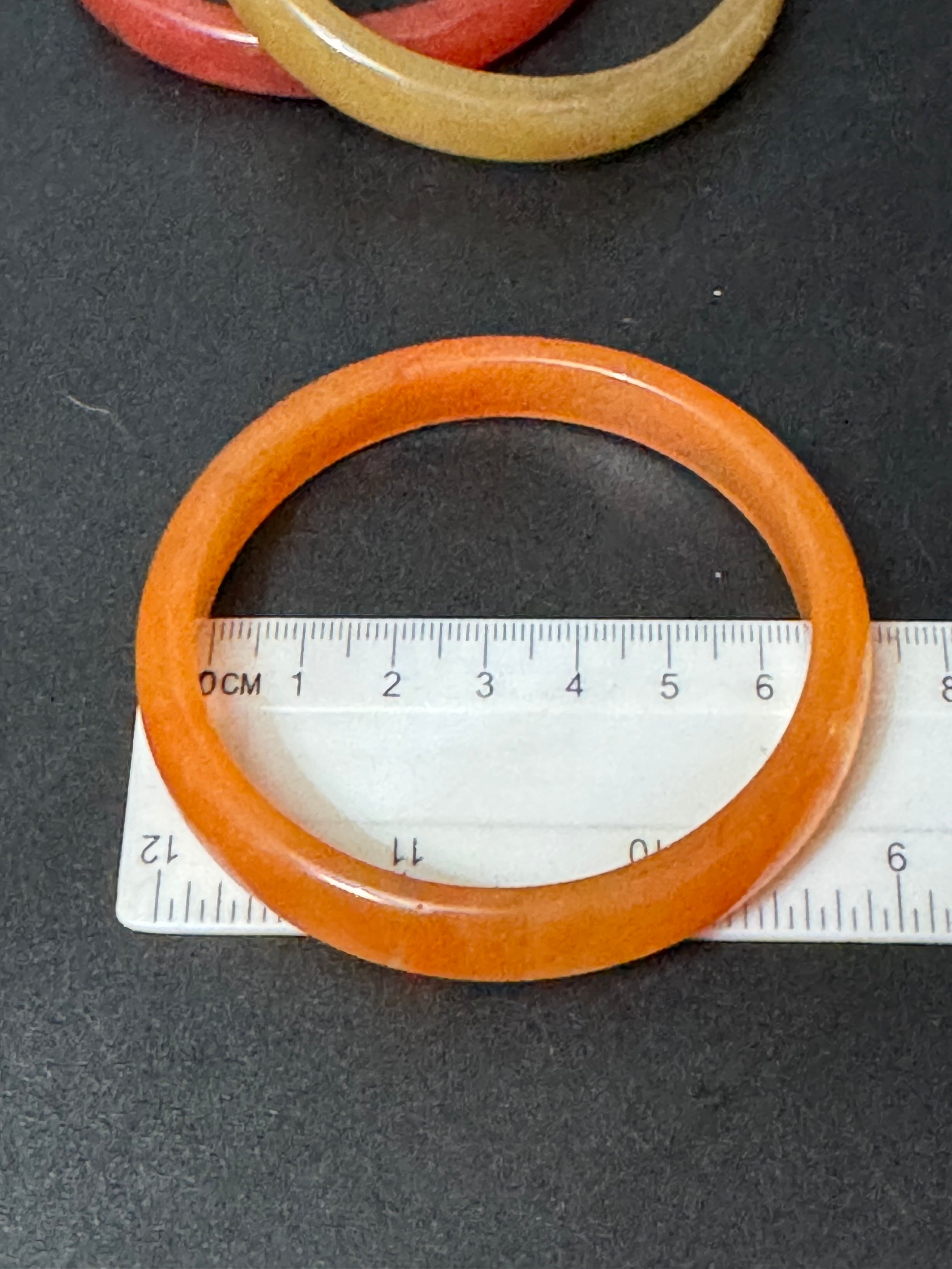 A trio of either orange or green tones mix and match acrylic bangles