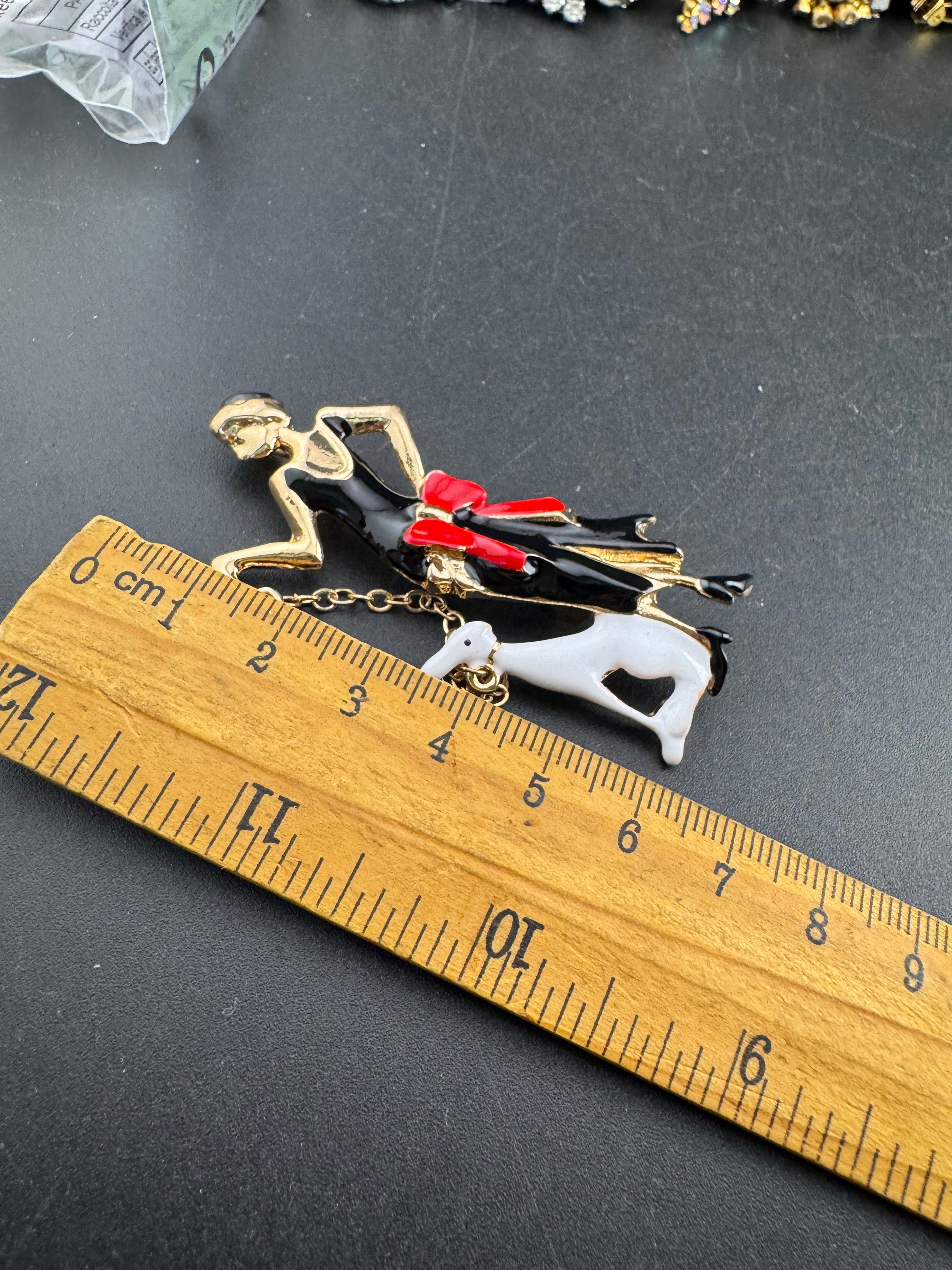 art deco lady with a dog on a lead brooch