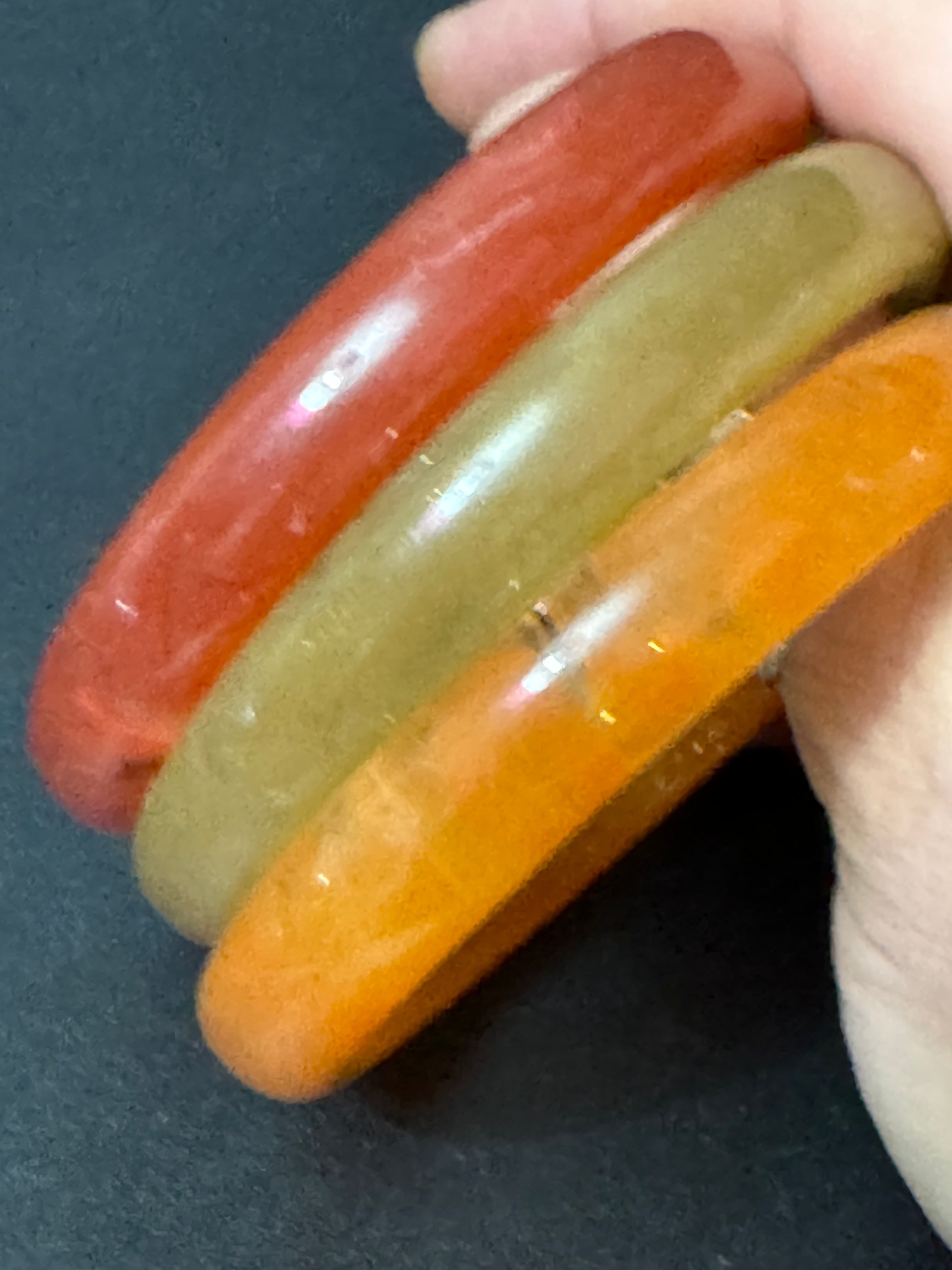 A trio of either orange or green tones mix and match acrylic bangles