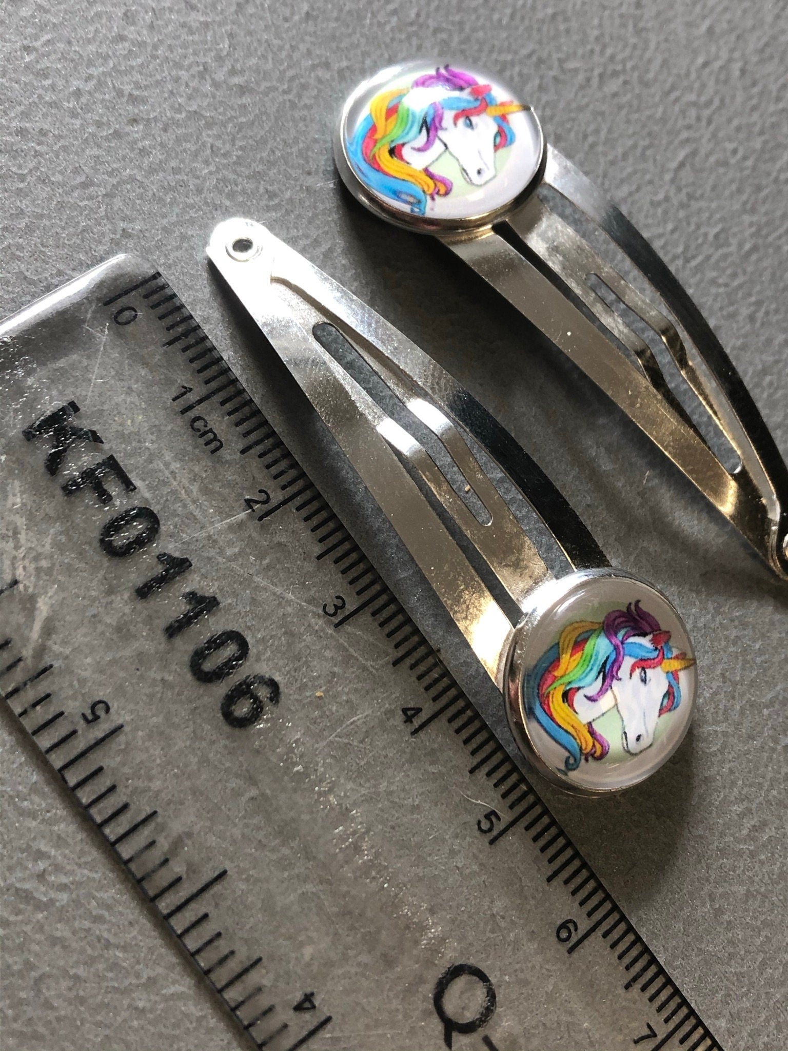 pair of Unicorn hair clips silver tone snap lock closure