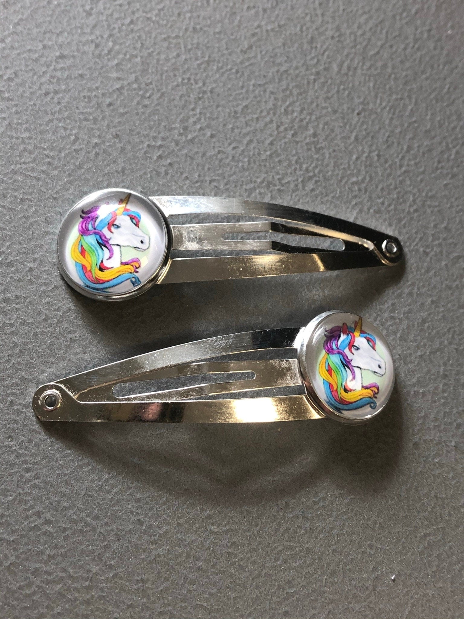 pair of Unicorn hair clips silver tone snap lock closure