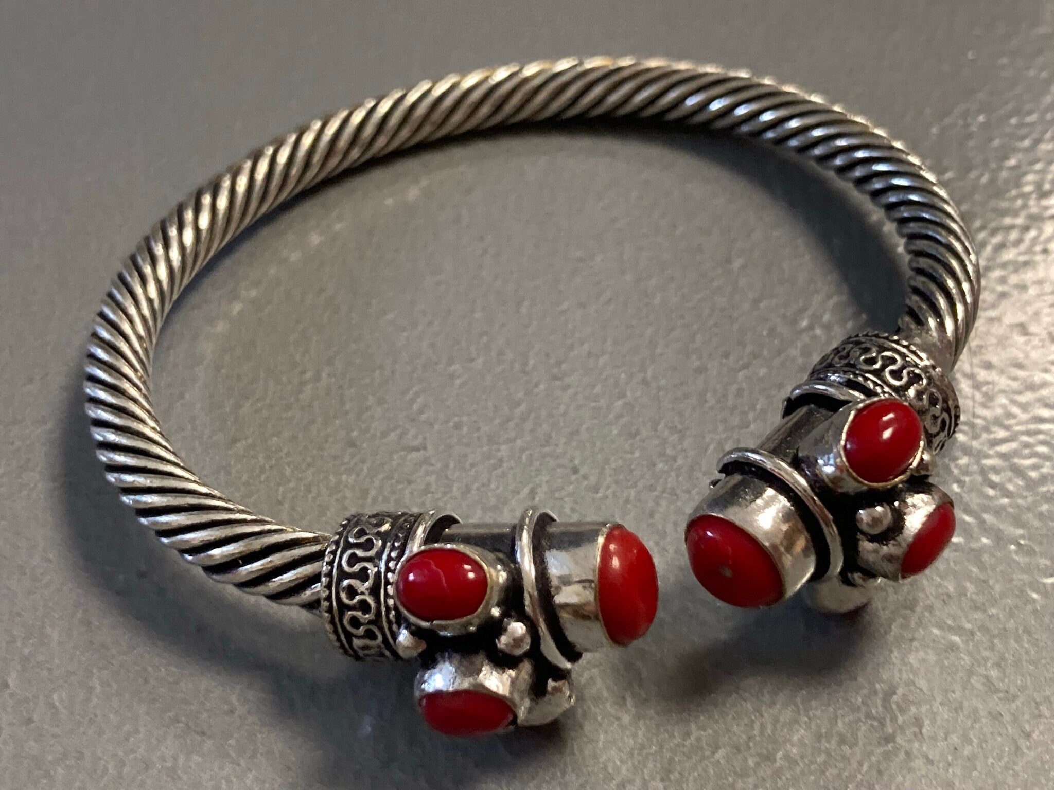 Silver tone torque cuff bangle bracelet with red coral cabochons