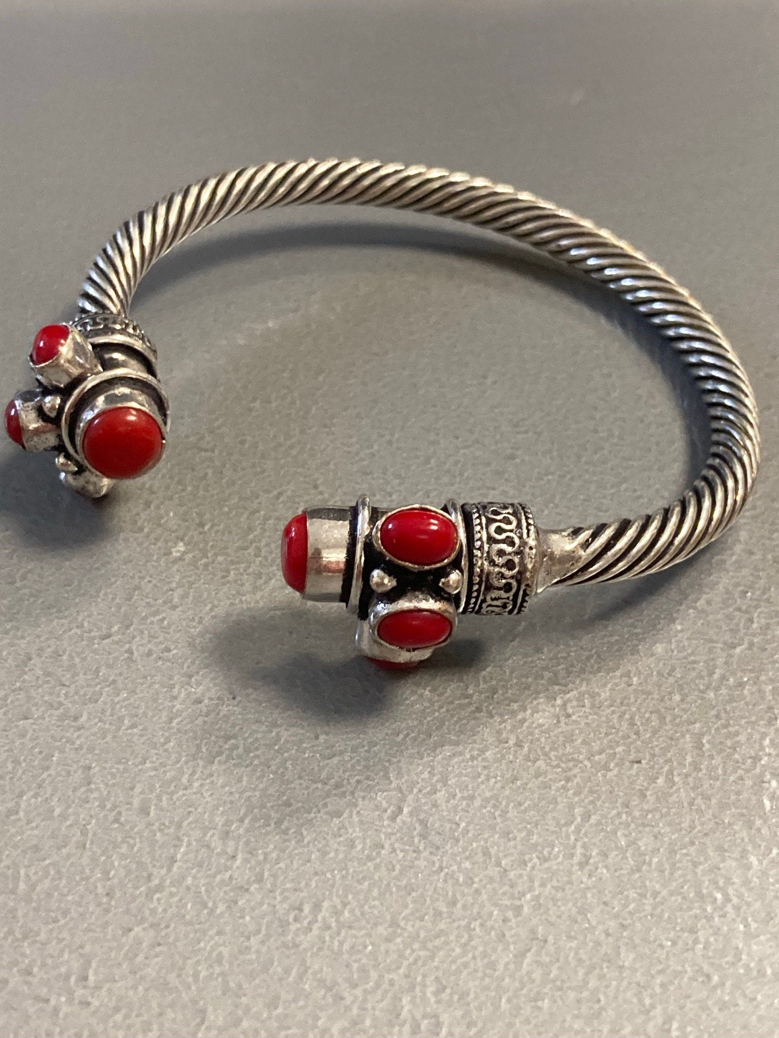 Silver tone torque cuff bangle bracelet with red coral cabochons
