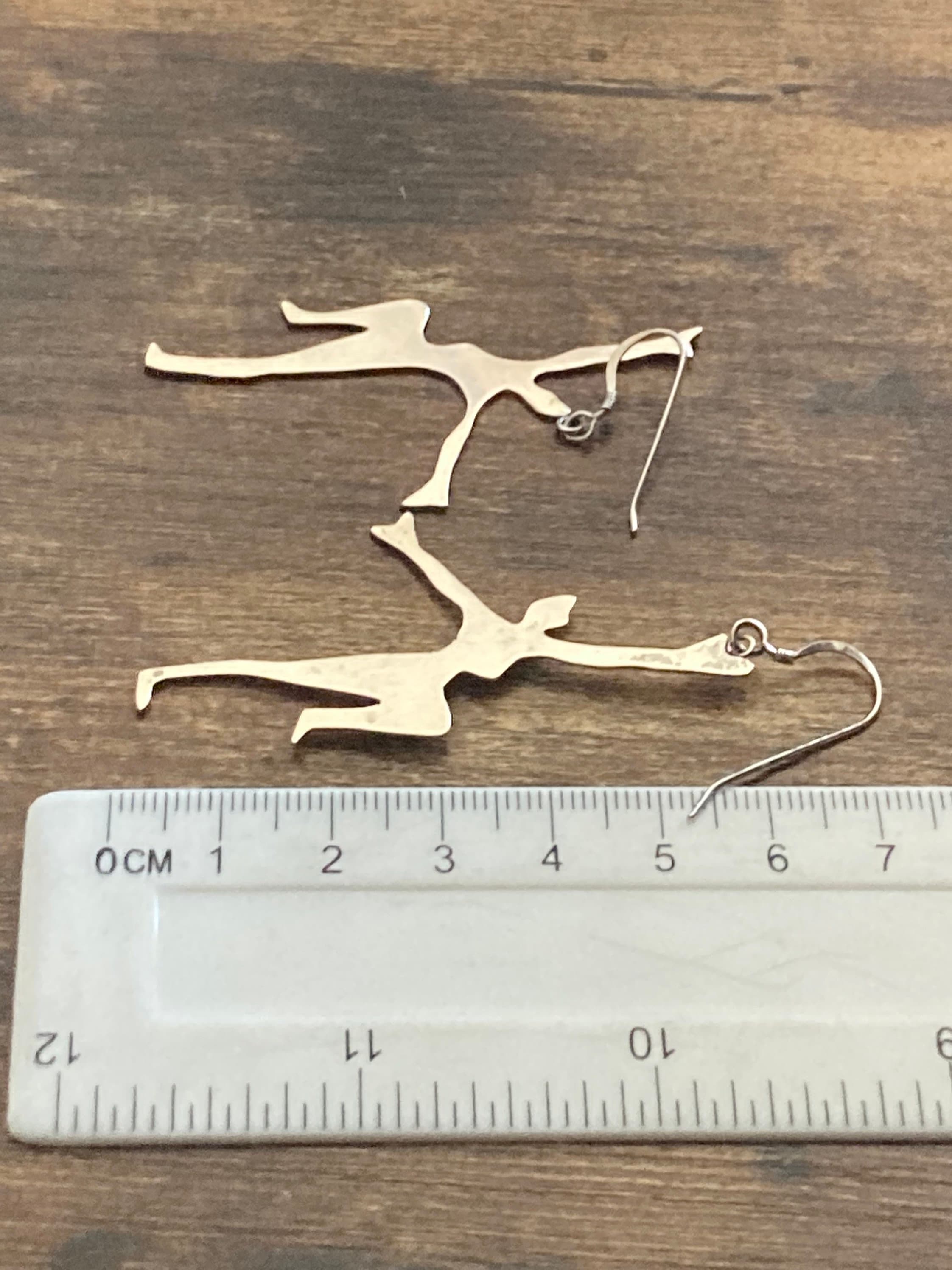 Unmarked silver 7cm long Art Deco dancing lady drop earrings pierced ears white metal