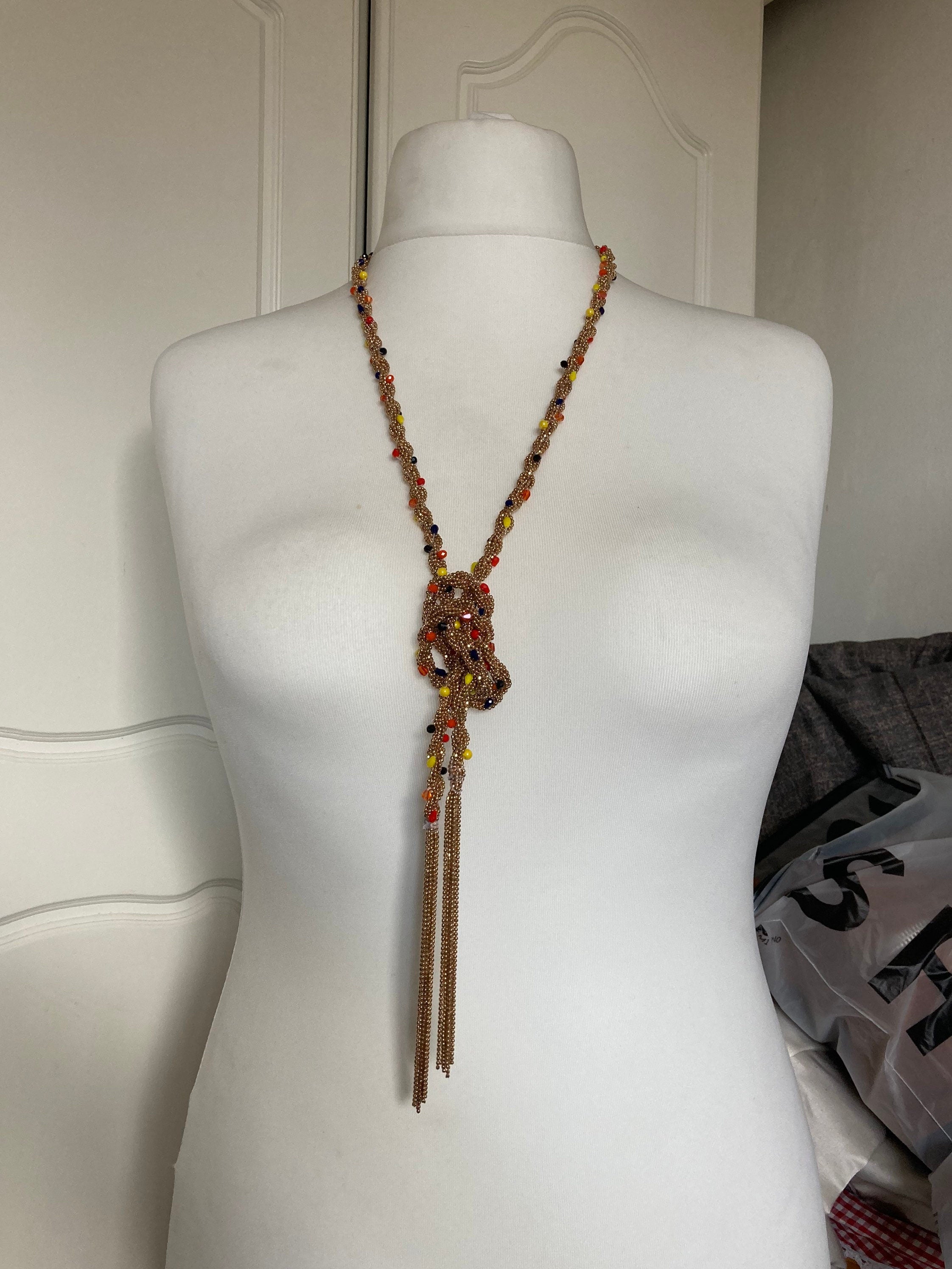140cm long gold tone tassel necklace with orange yellow woven seed bead flapper length