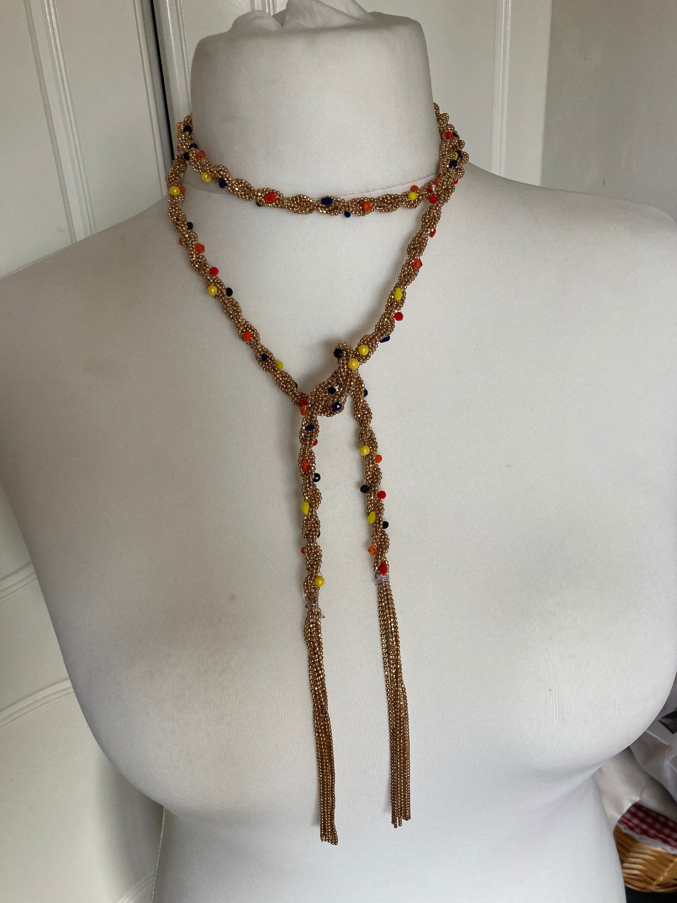 140cm long gold tone tassel necklace with orange yellow woven seed bead flapper length