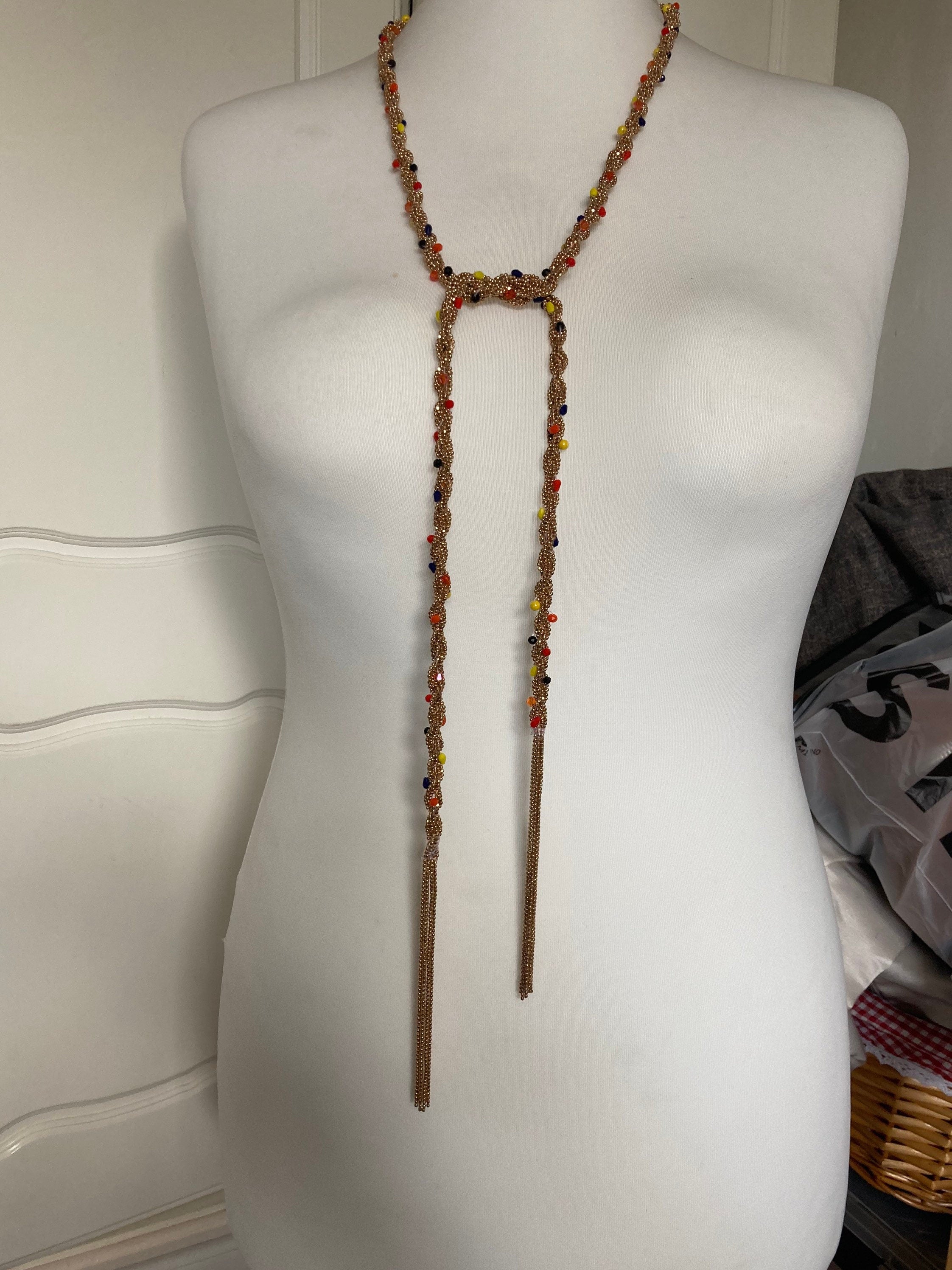 140cm long gold tone tassel necklace with orange yellow woven seed bead flapper length