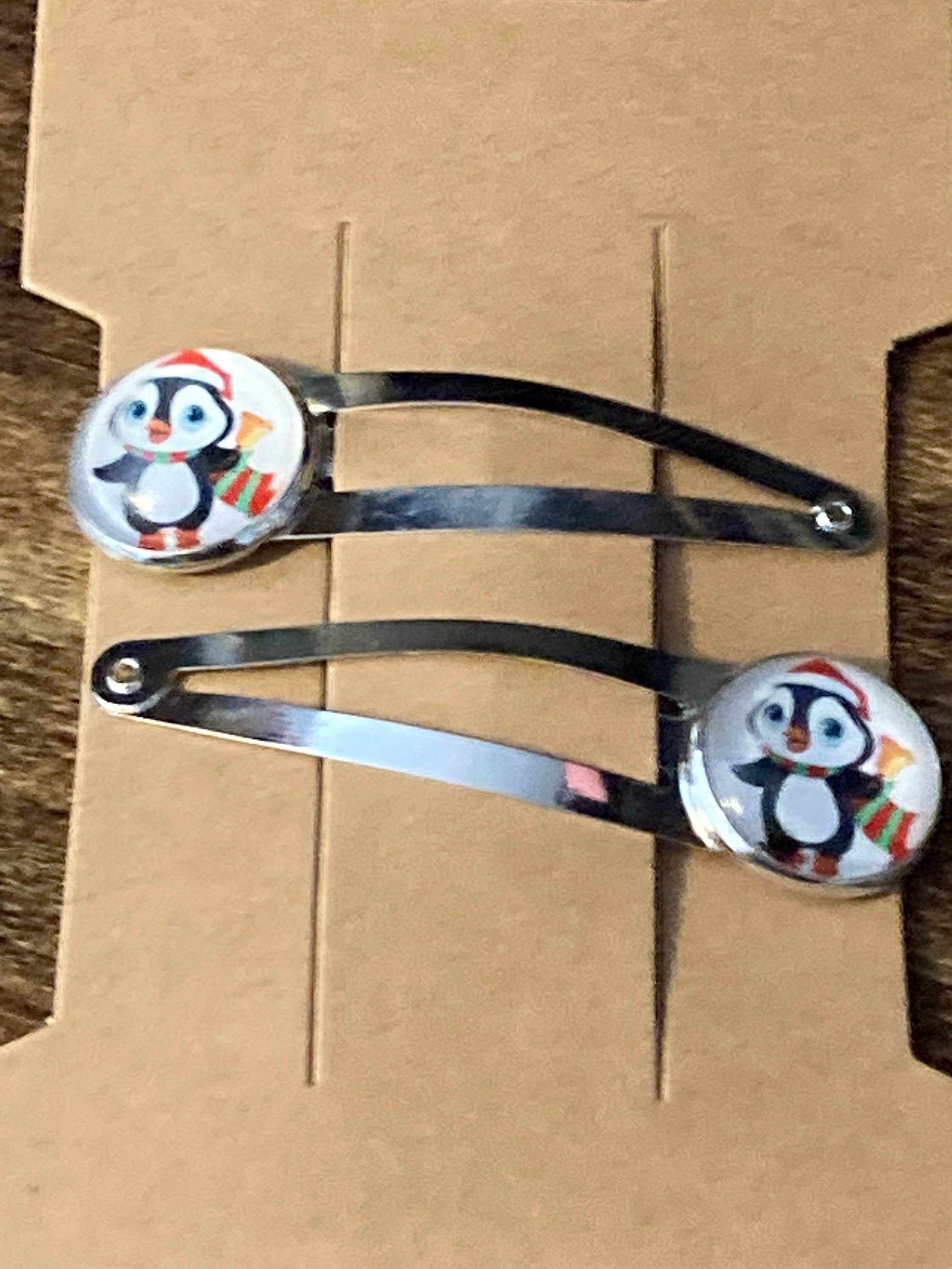 Pair of silver Christmas penguins hair slides
