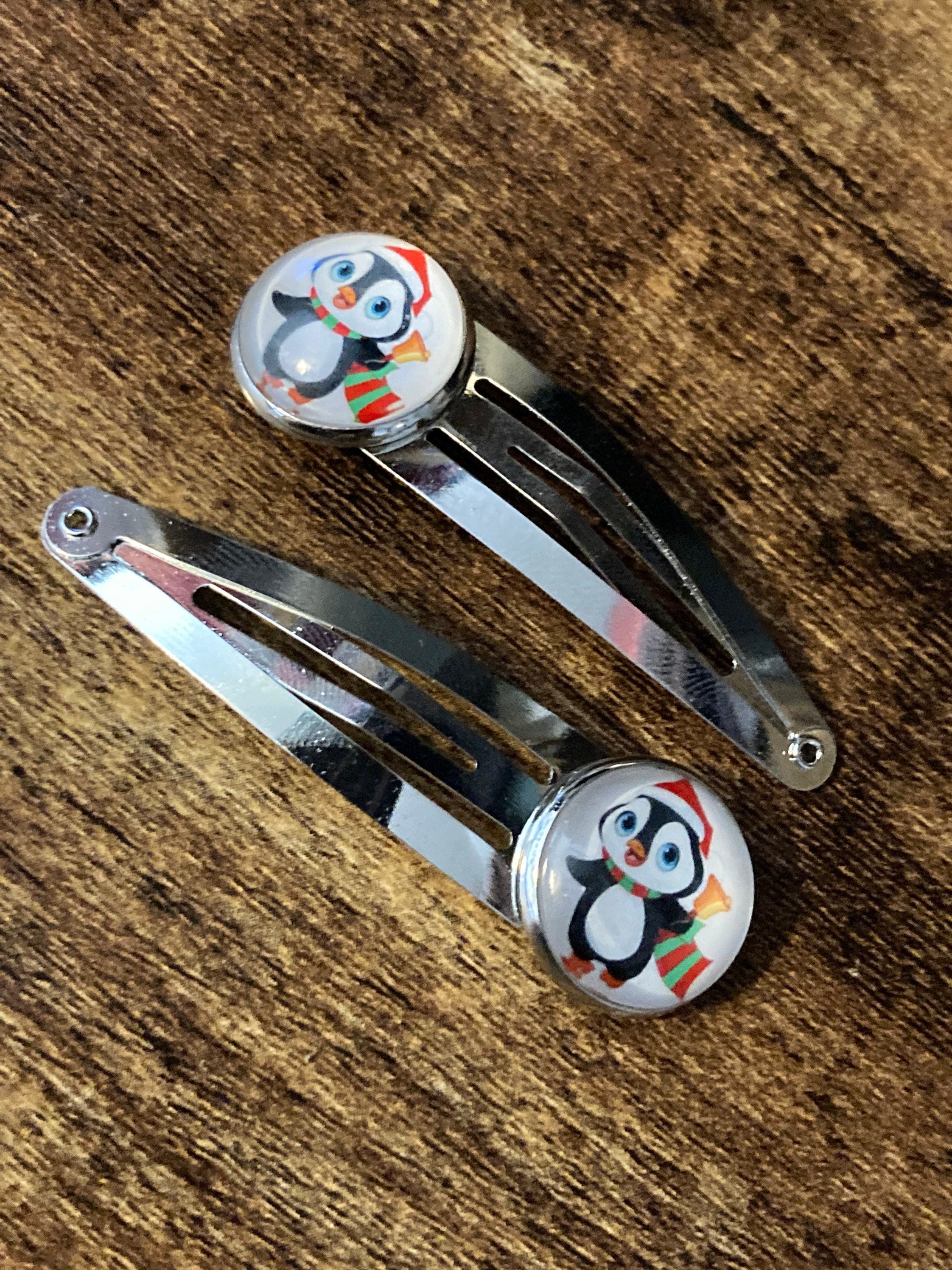 Pair of silver Christmas penguins hair slides