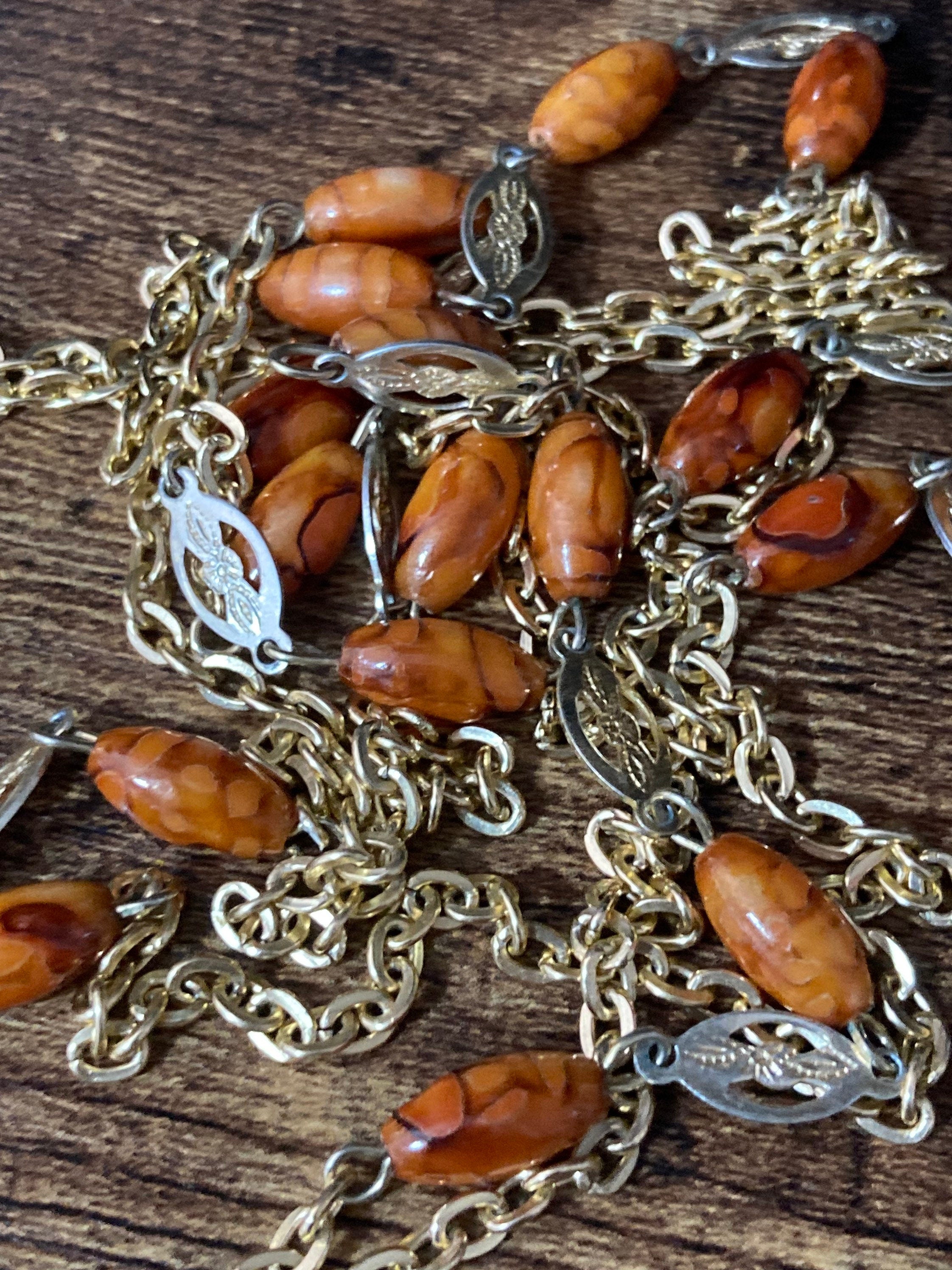 gold tone brown orange plastic beaded flapper length station necklace 125cm long