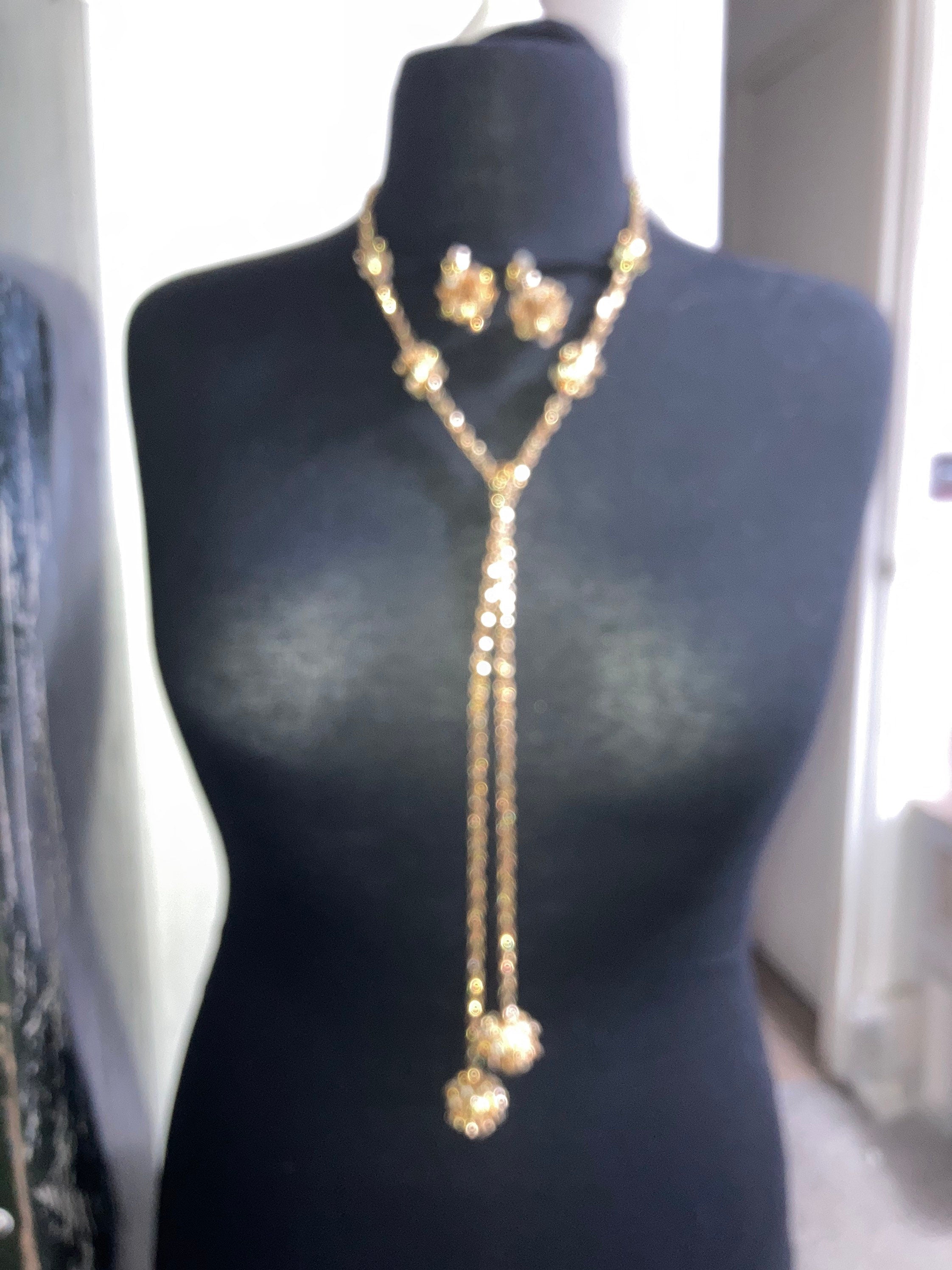 long gold tone rhinestone ball link soutoir knot necklace and matching clip earrings