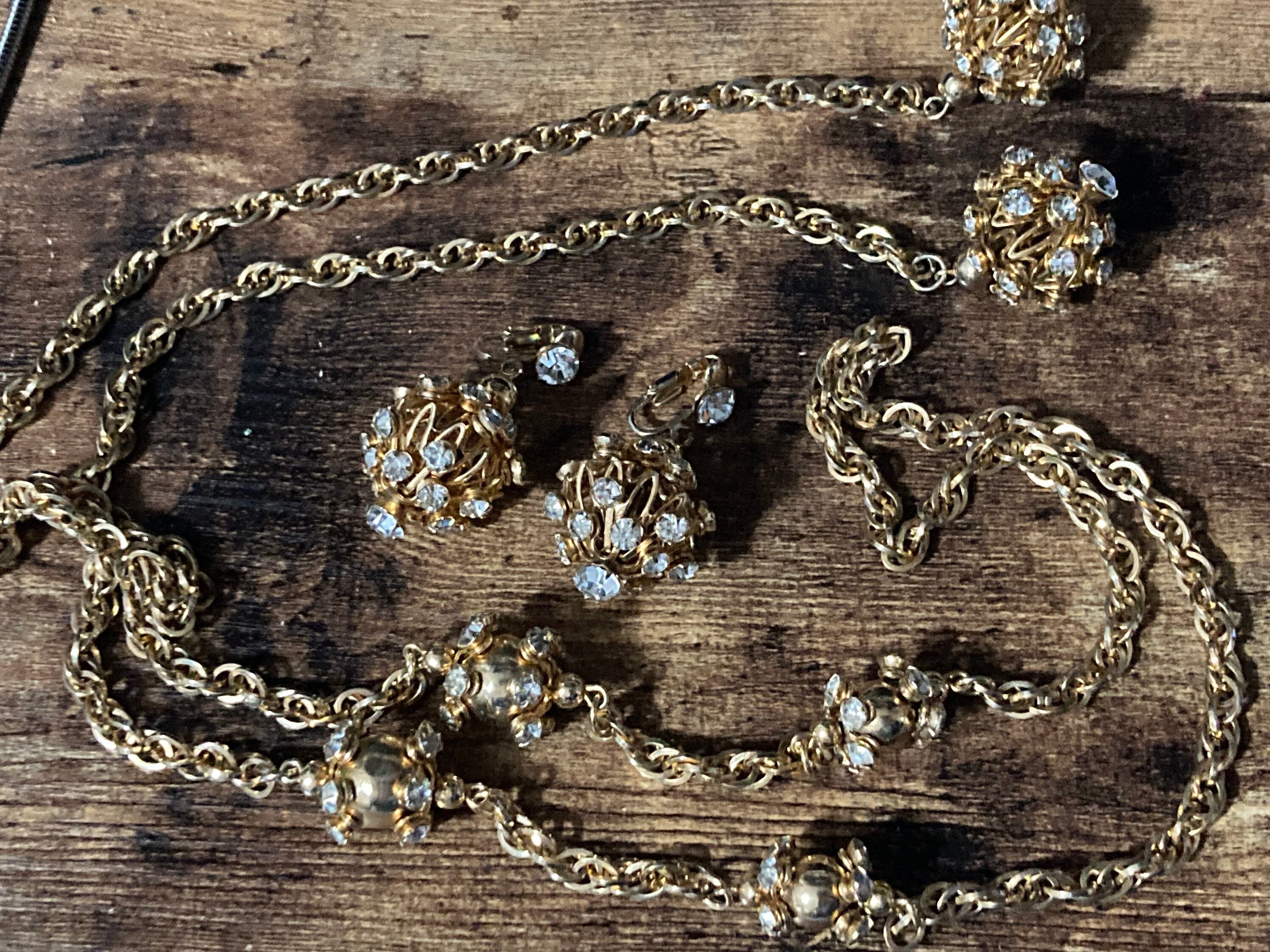 long gold tone rhinestone ball link soutoir knot necklace and matching clip earrings