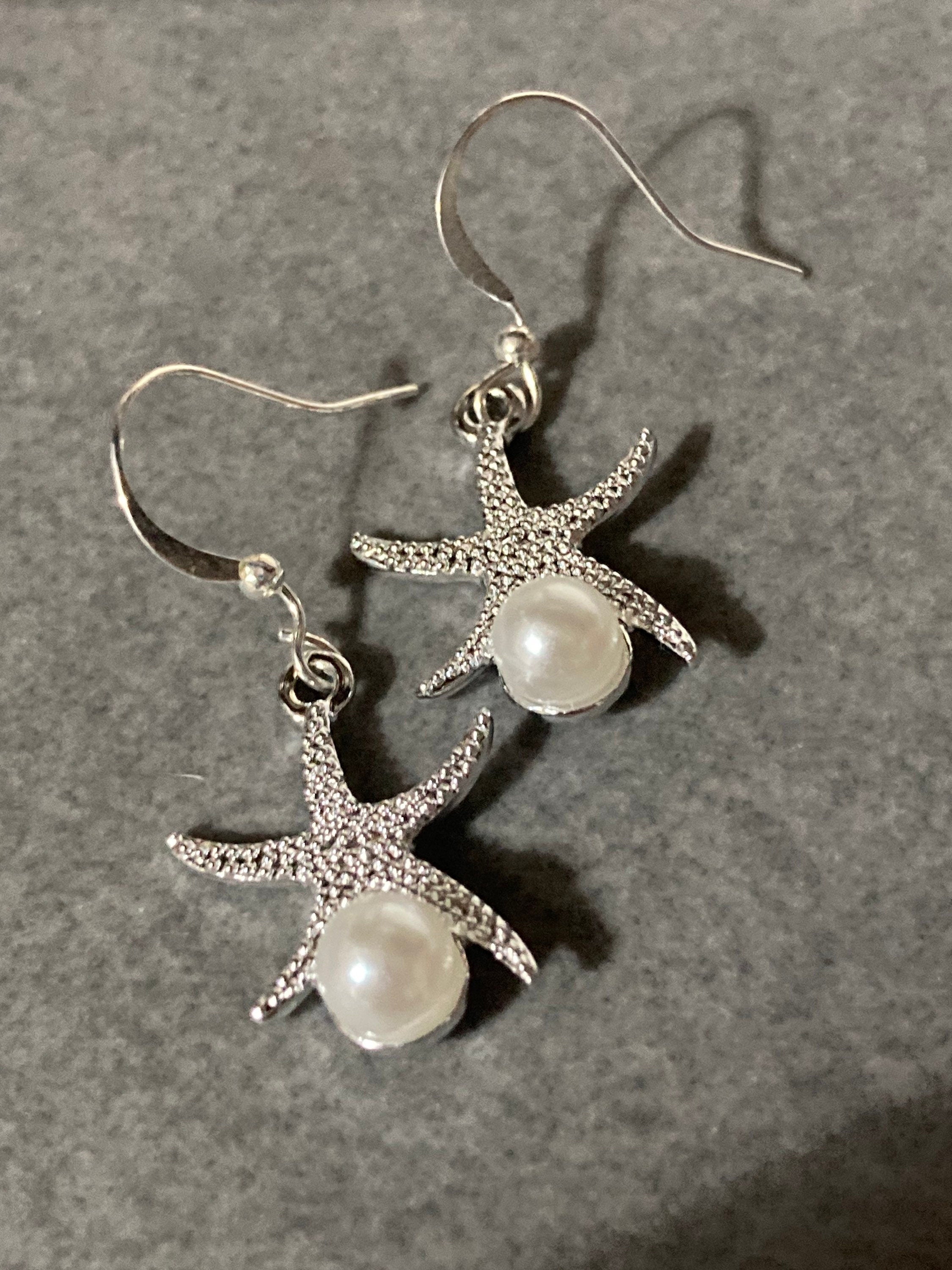 silve and pearl starfish earrings, pierced ears
