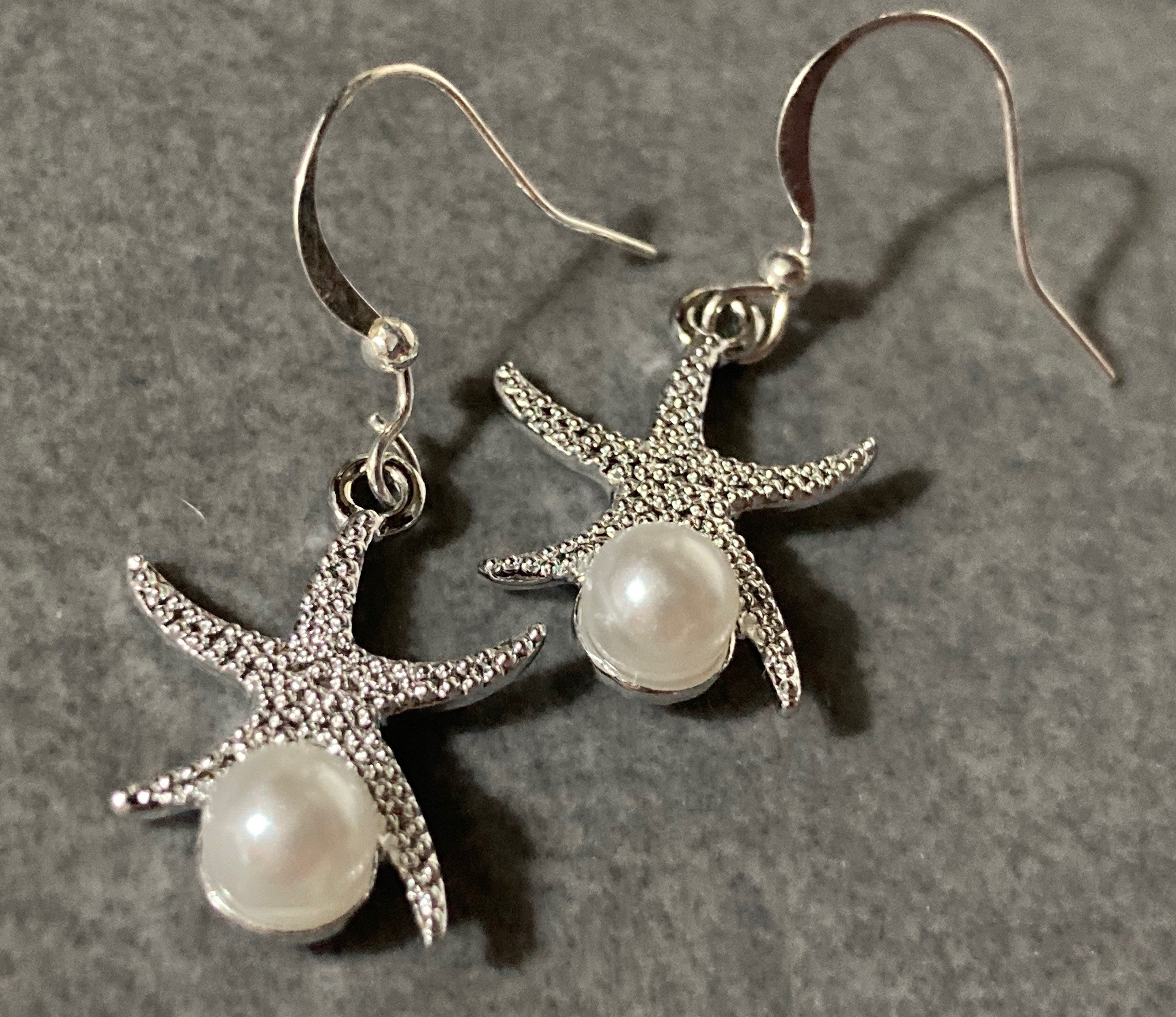 silve and pearl starfish earrings, pierced ears