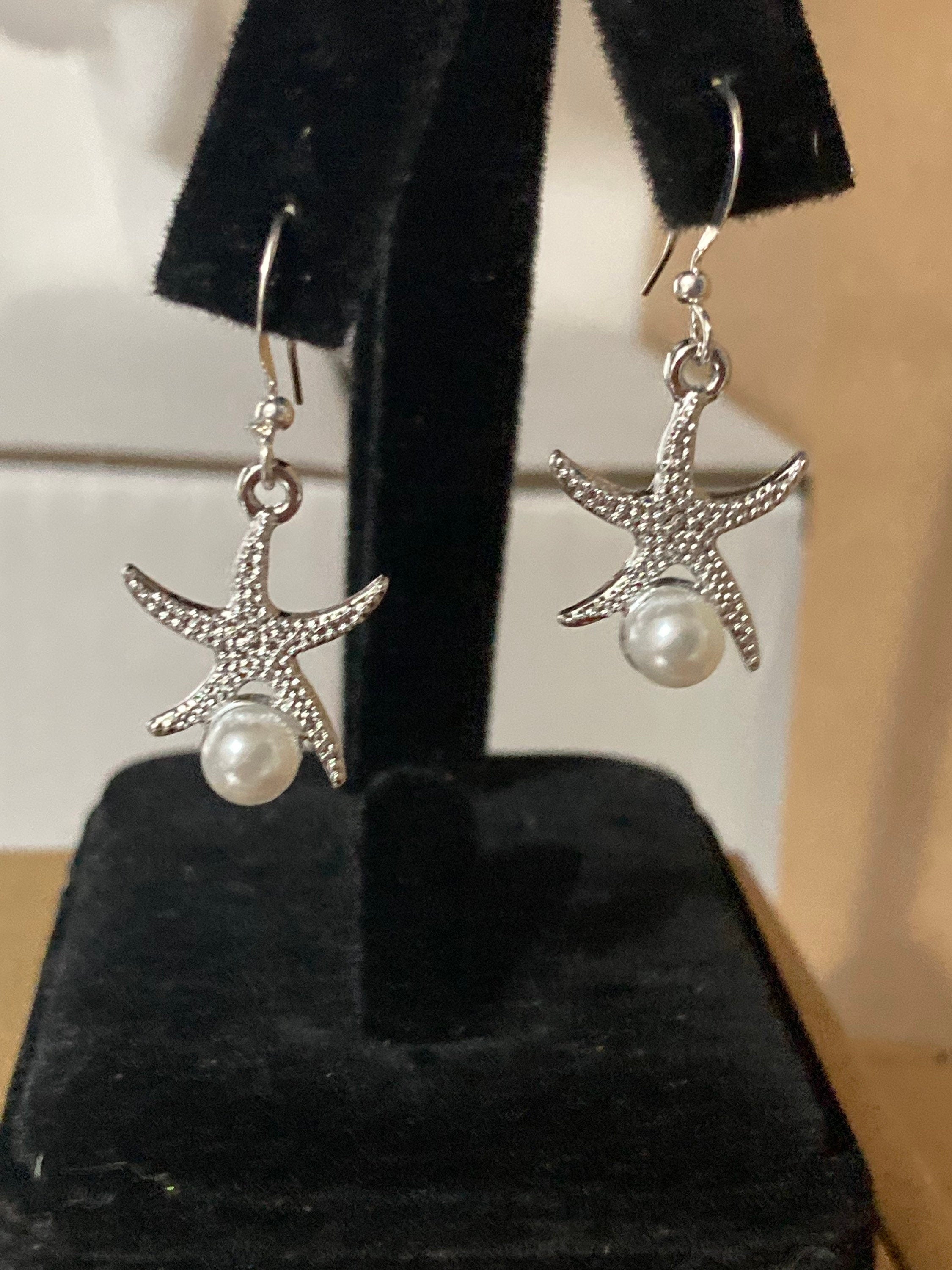 silve and pearl starfish earrings, pierced ears