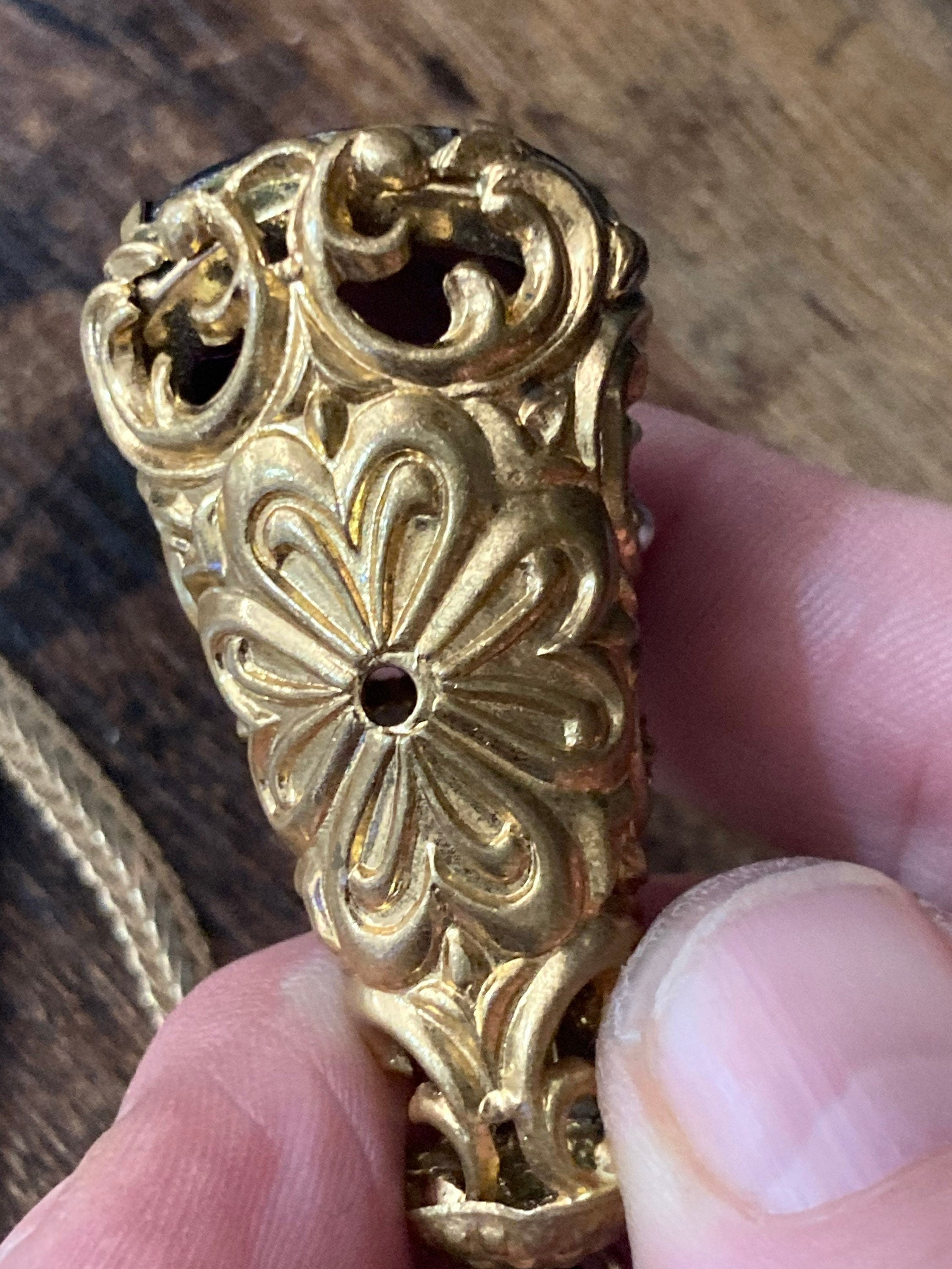 Vintage gold tone ornate gilt metal cone pendant with faux pearls and purple glass cabochon on flat chain