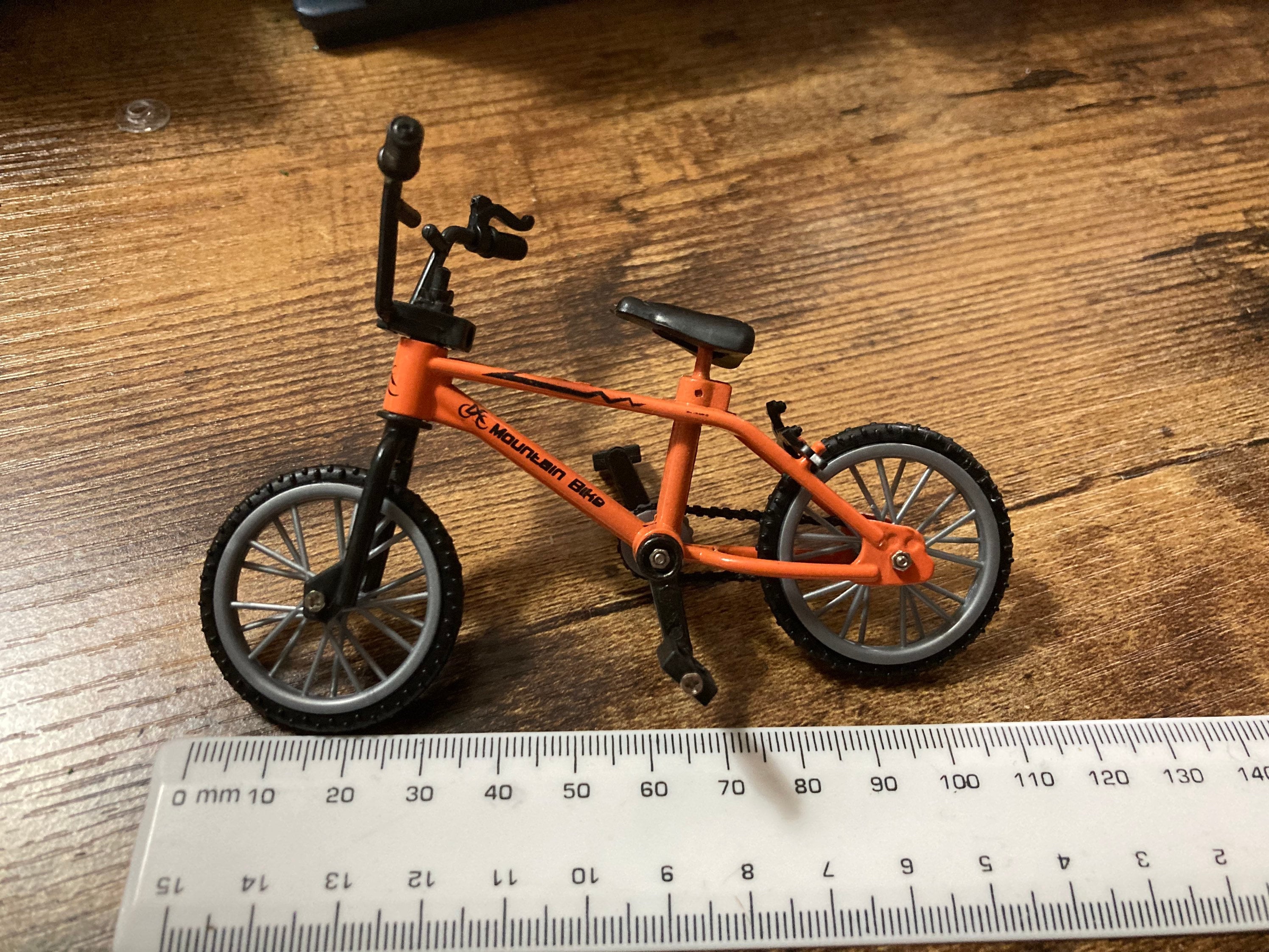 Miniature plastic orange mountain bike BMX cake topper decoration