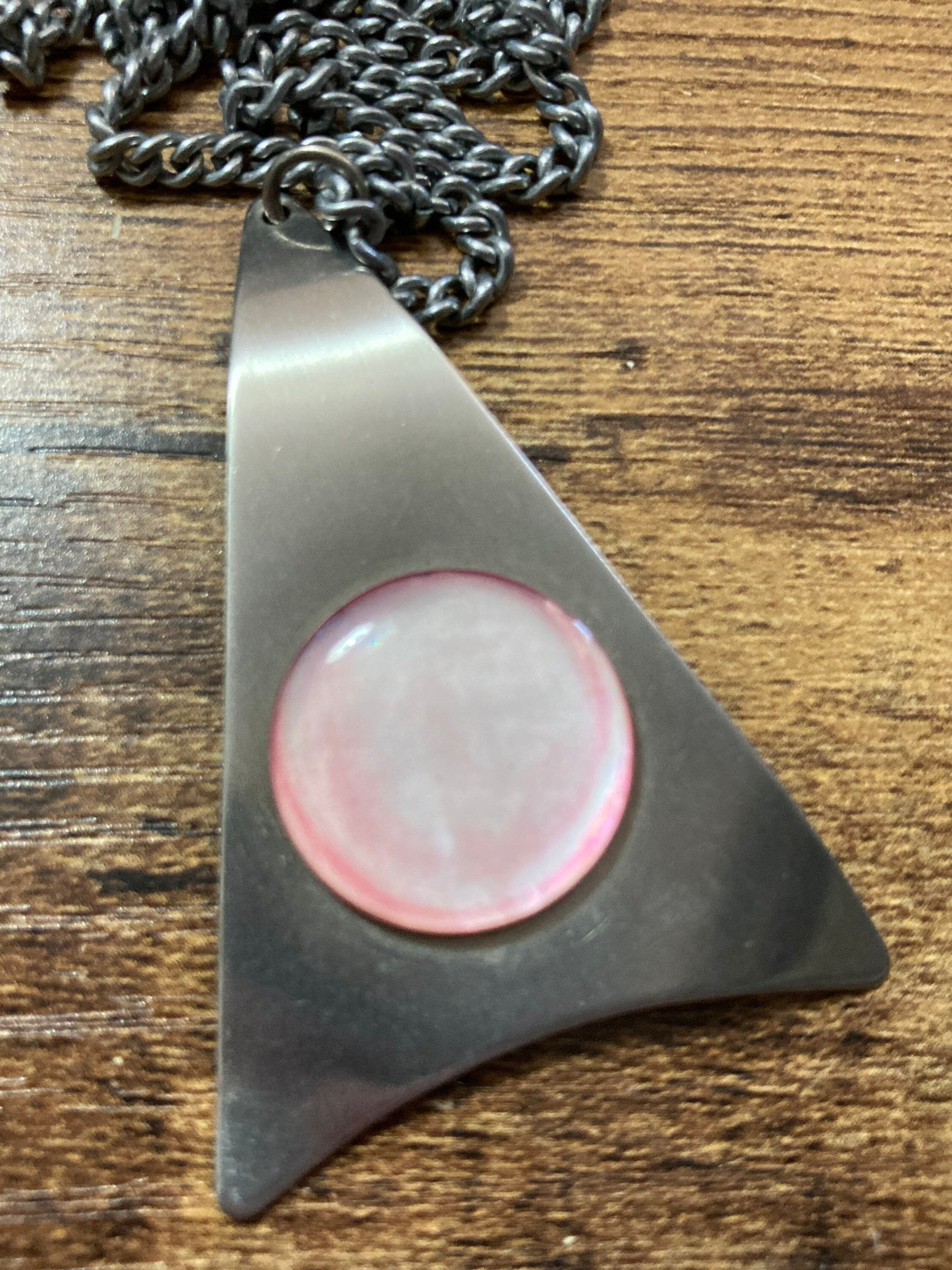 Vintage Modernist stainless steel pendant necklace with central pale pink cabochon