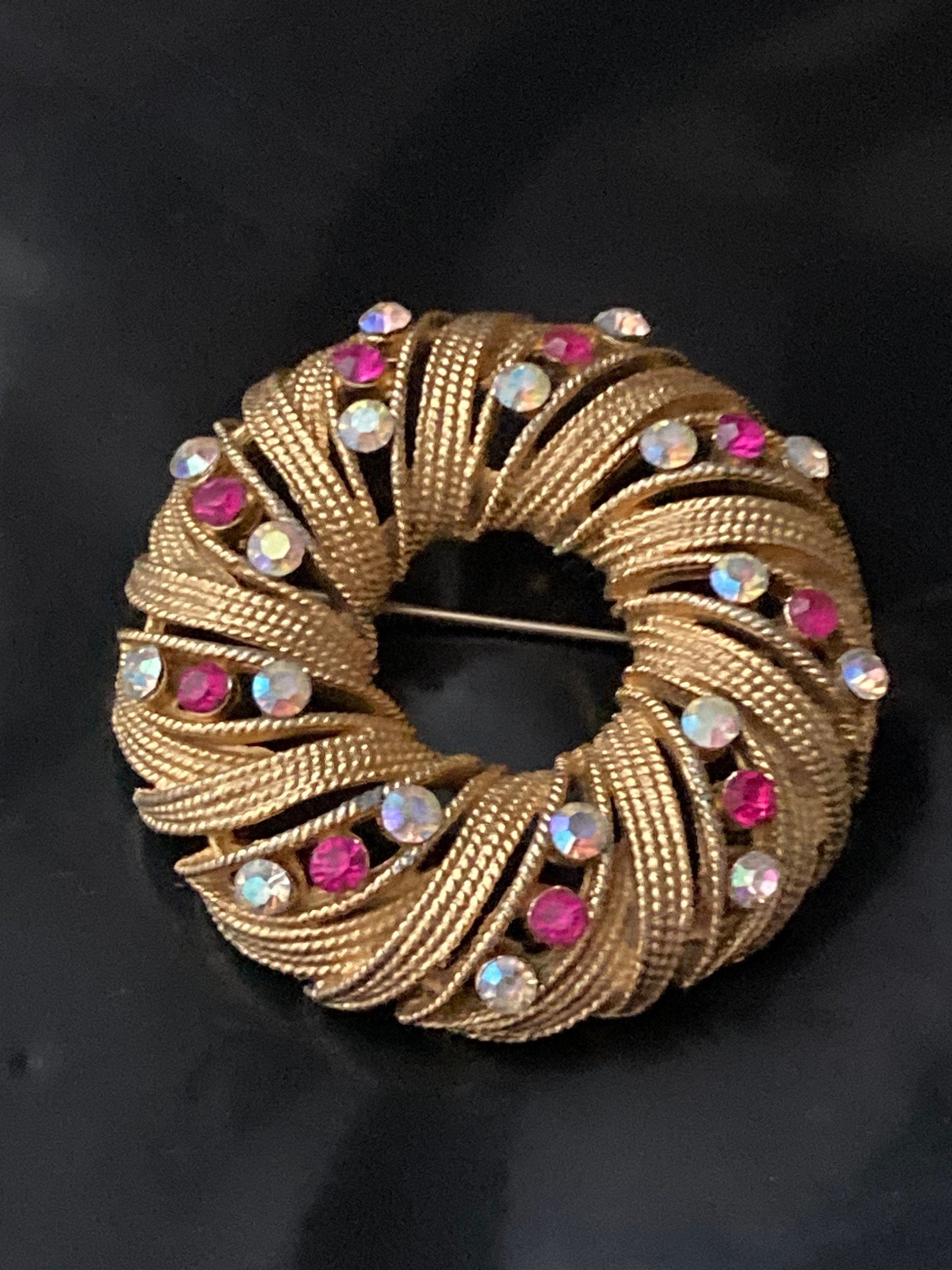 pink AB diamanté swirl brooch, gold tone round mid century
