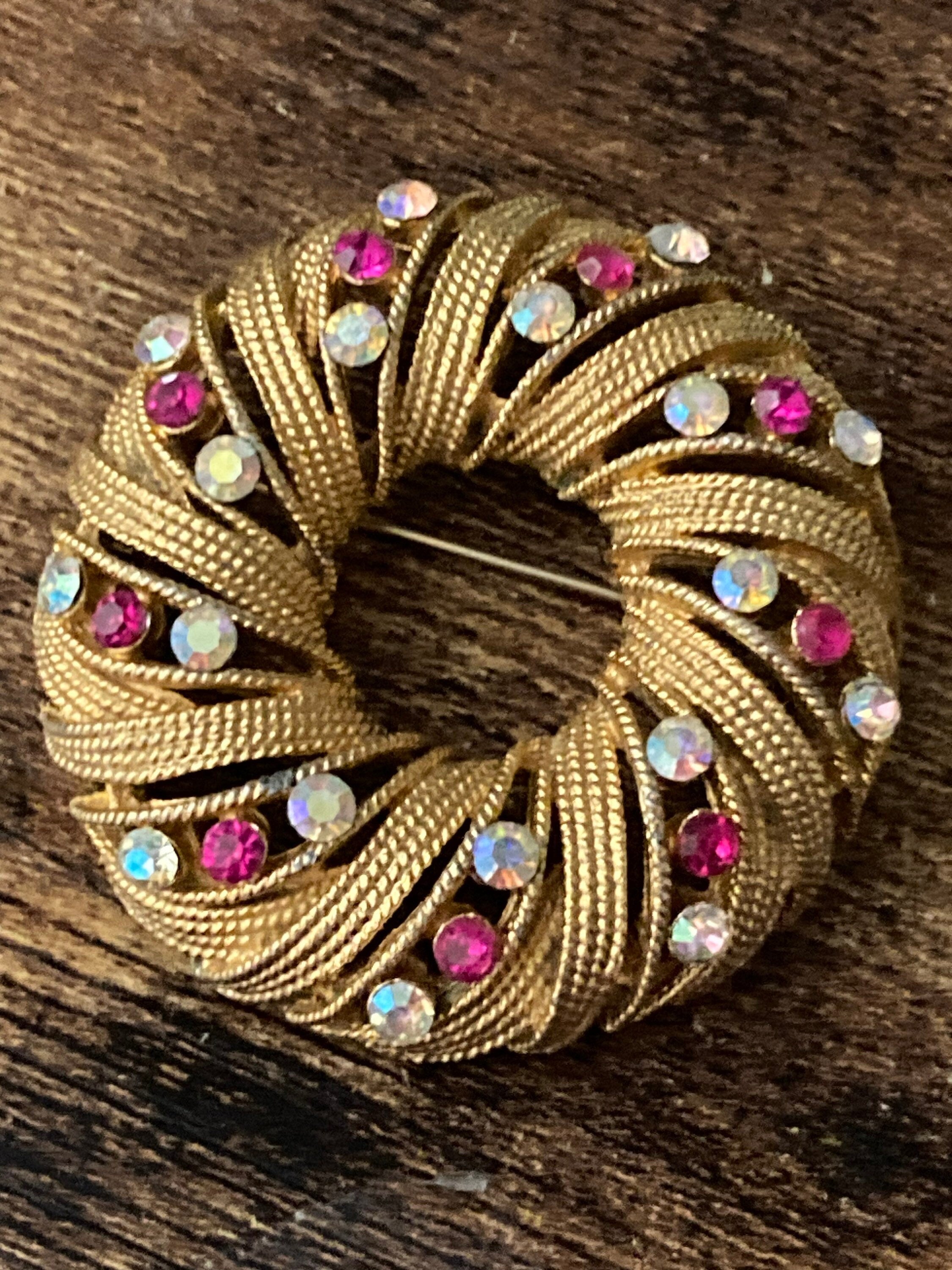 pink AB diamanté swirl brooch, gold tone round mid century