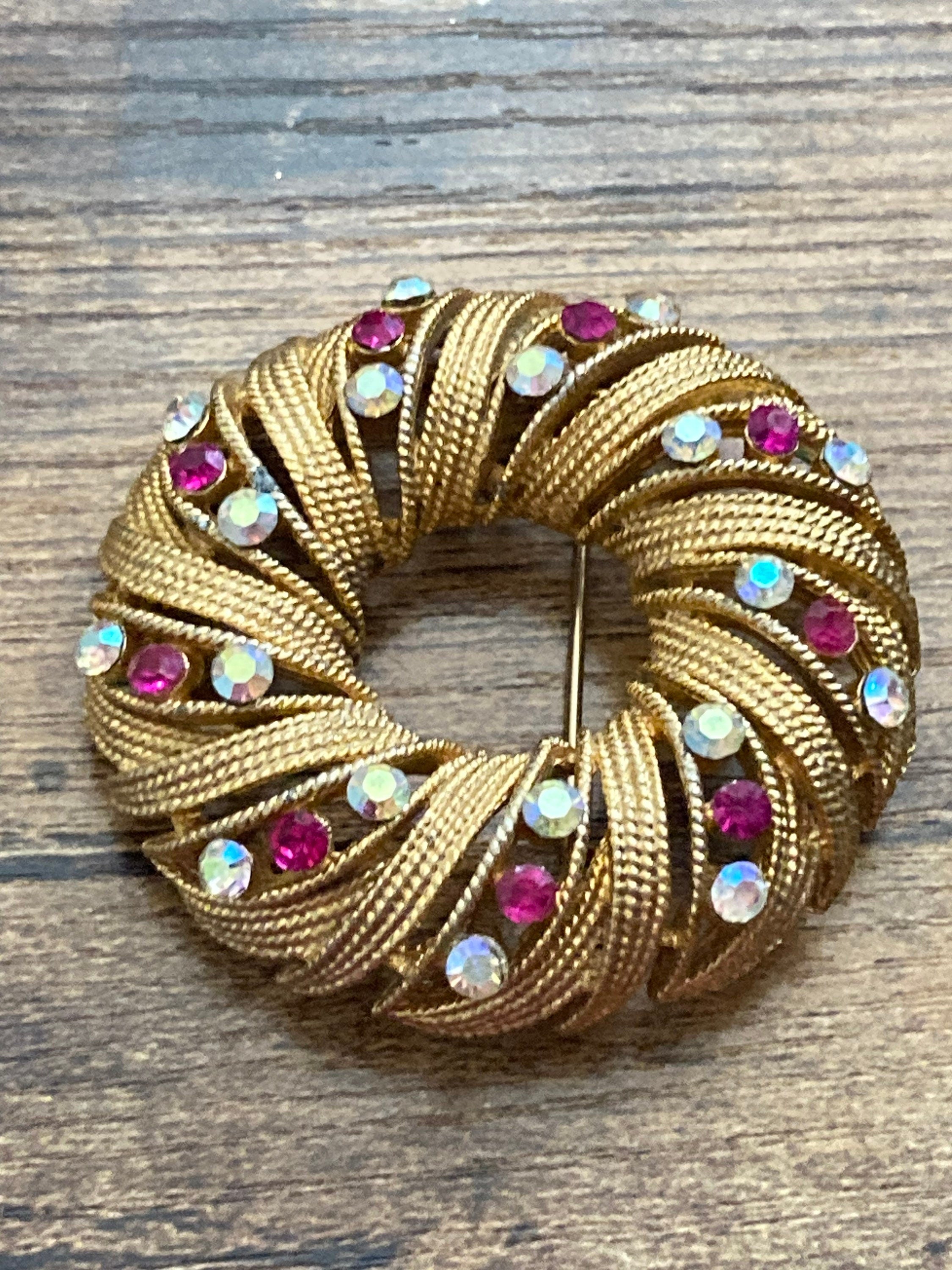 pink AB diamanté swirl brooch, gold tone round mid century