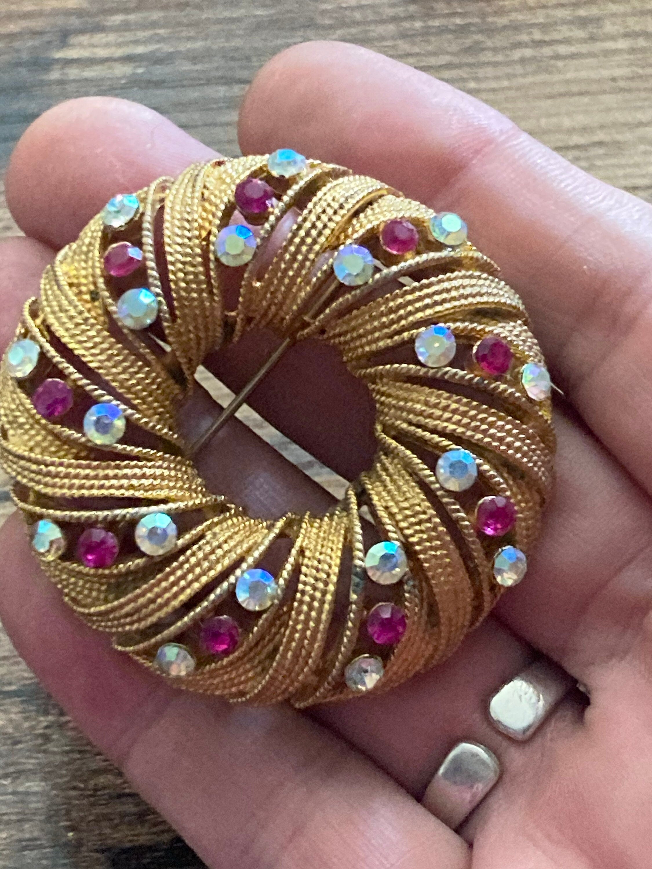 pink AB diamanté swirl brooch, gold tone round mid century