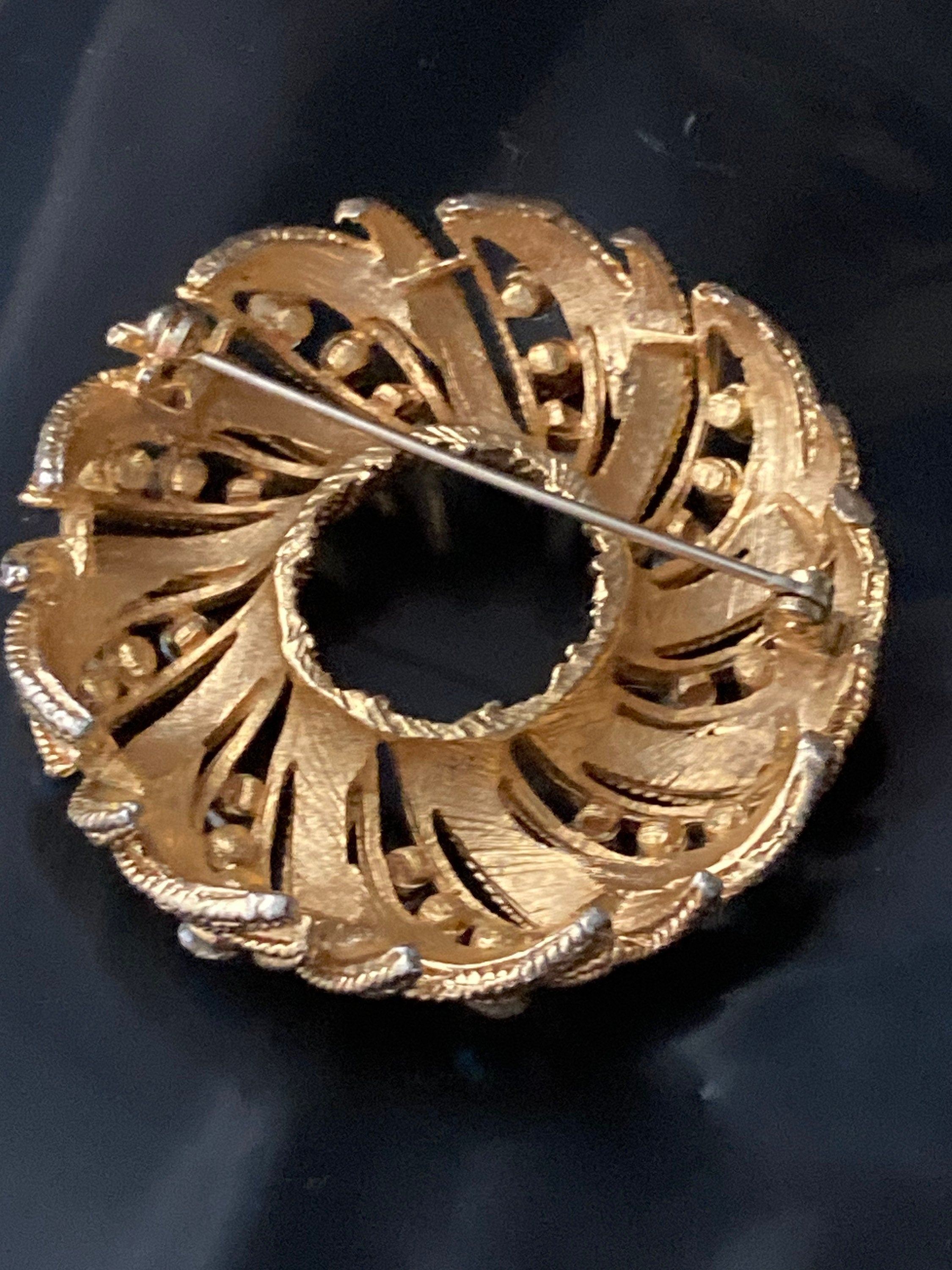 pink AB diamanté swirl brooch, gold tone round mid century