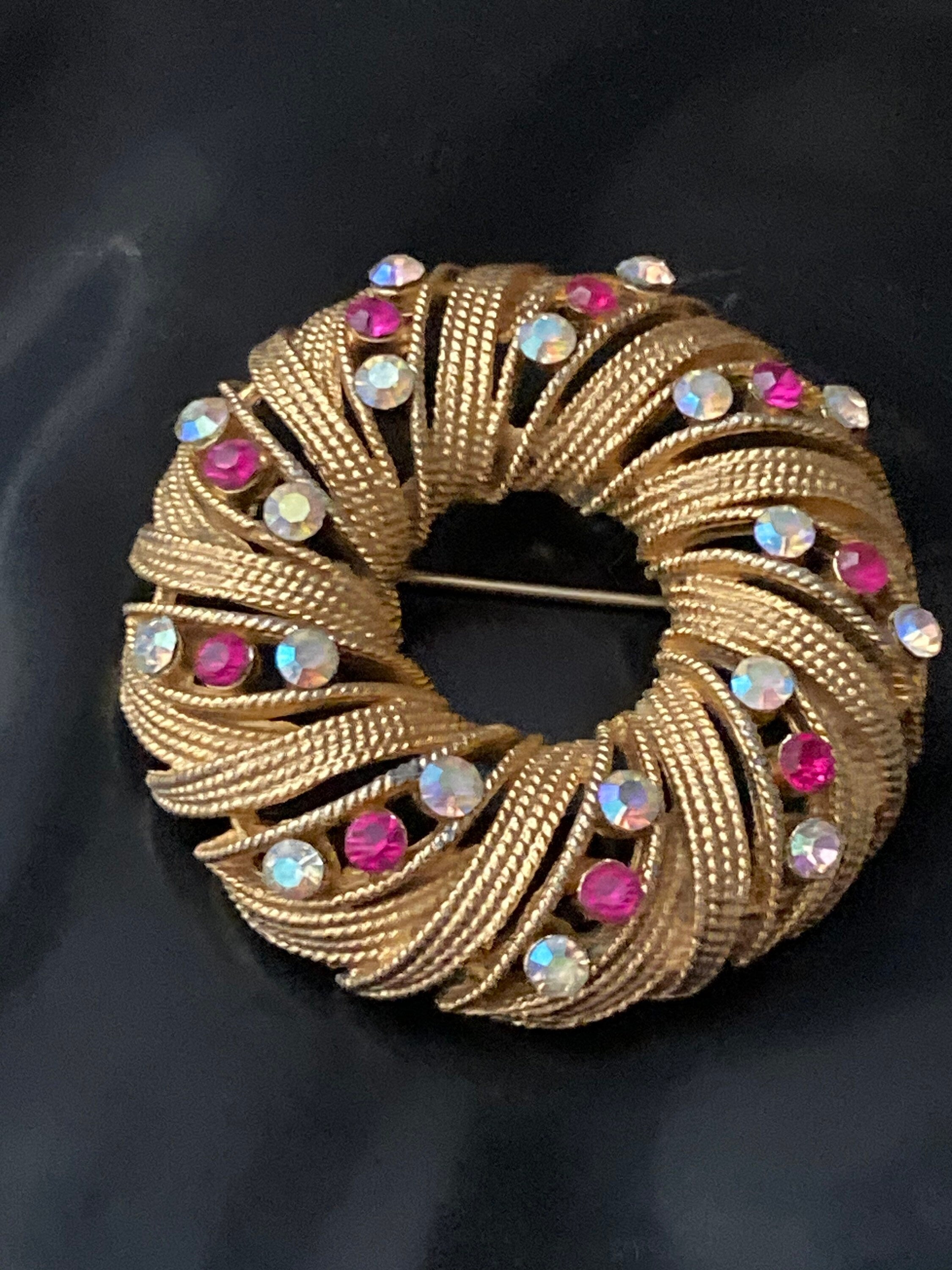 pink AB diamanté swirl brooch, gold tone round mid century