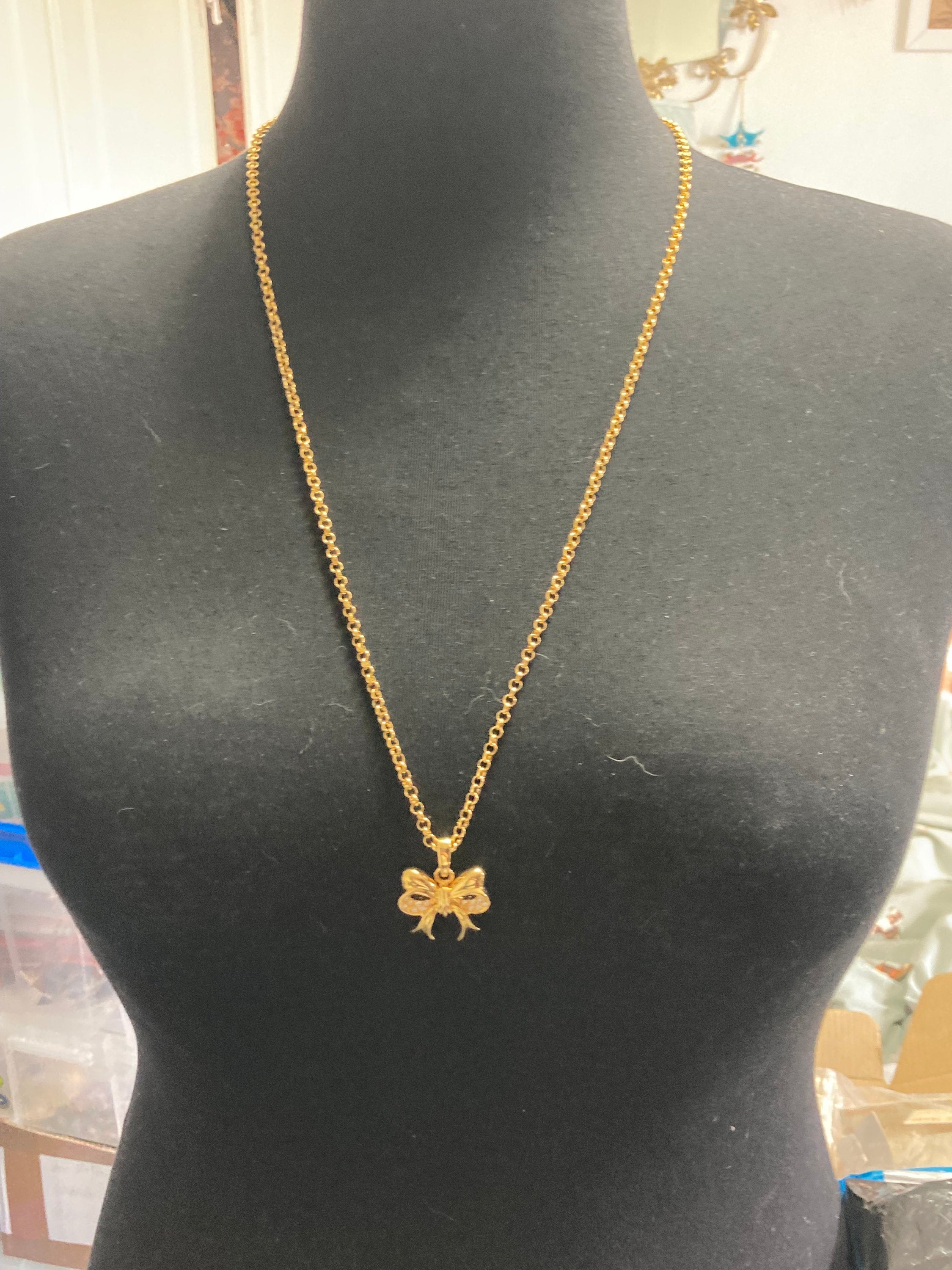 Signed Joan Rivers gold plated clear diamanté bow pendant necklace