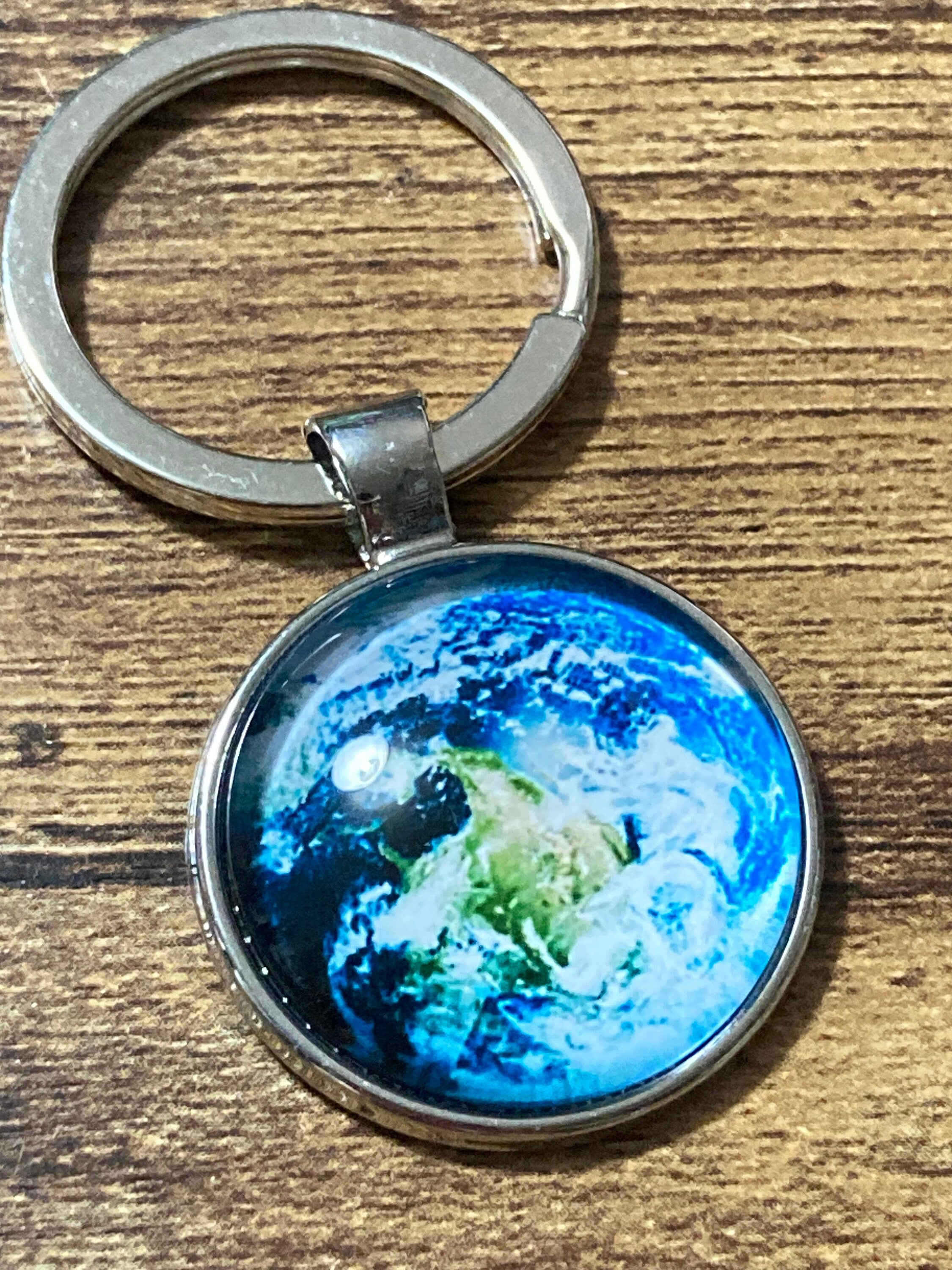 Aerial view of earth globe world silver tone keyring glass cabochon