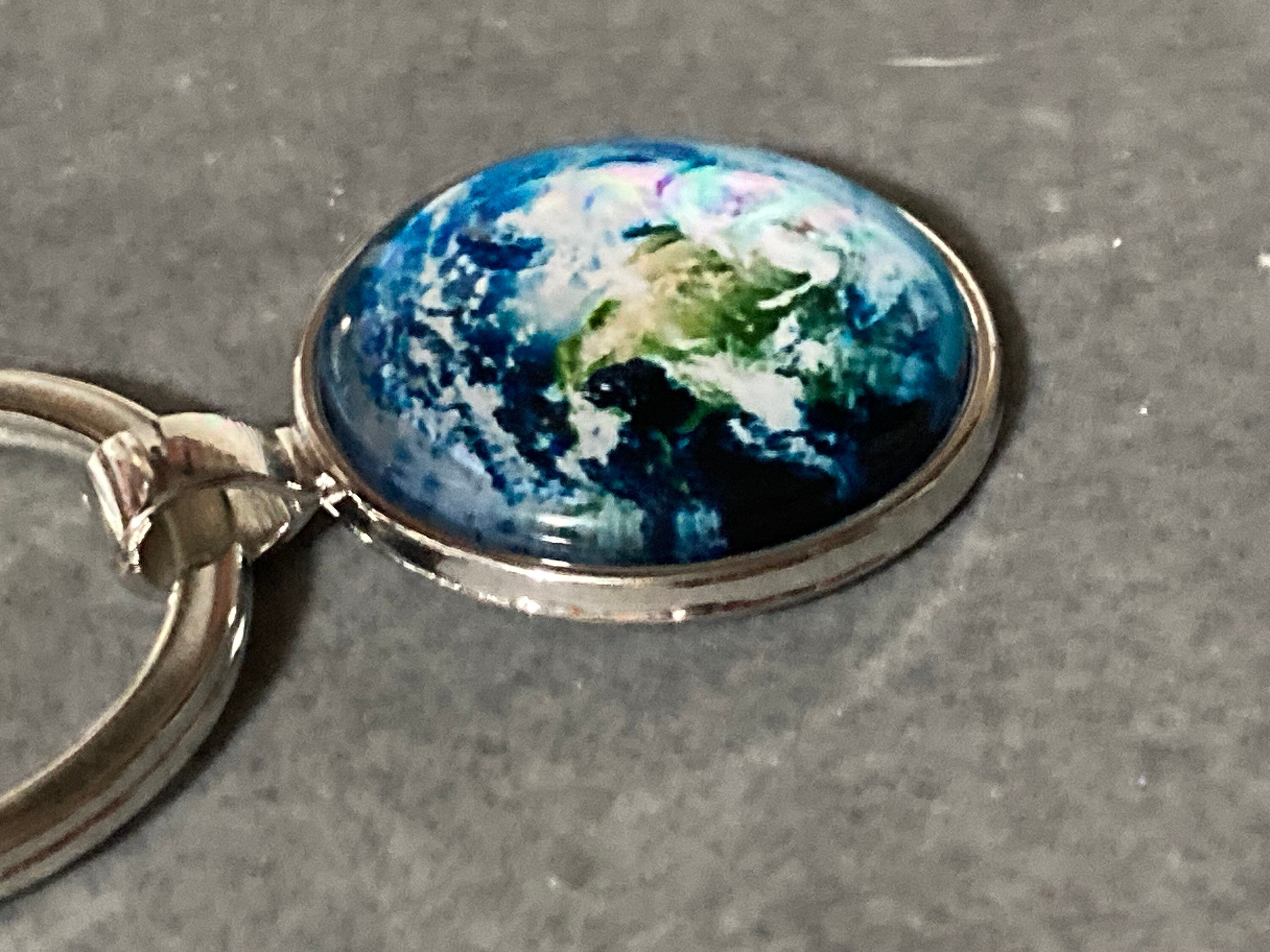 Aerial view of earth globe world silver tone keyring glass cabochon