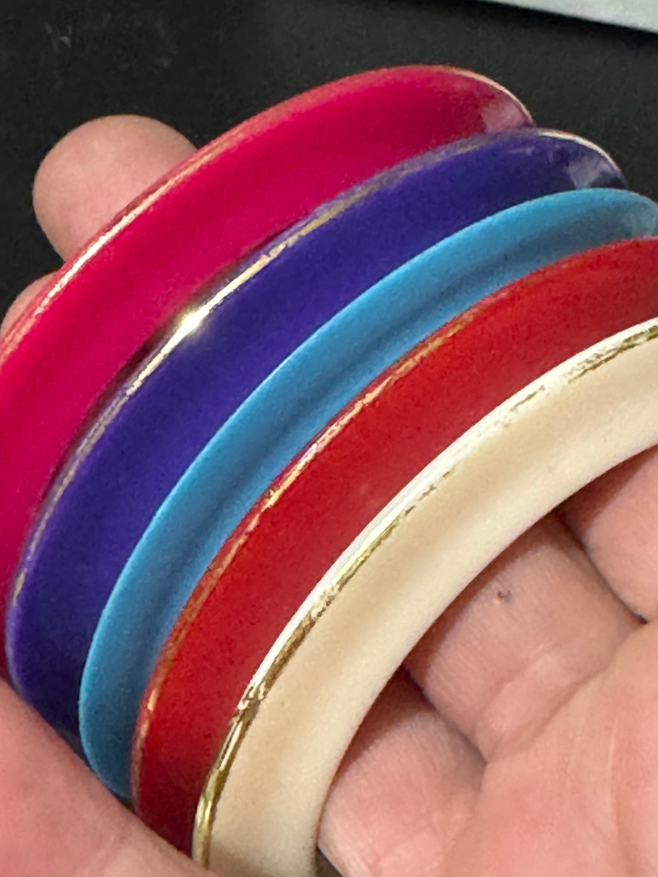 Vintage stack of coloured red purple blue cream pink plastic bangles retro acrylic bracelets