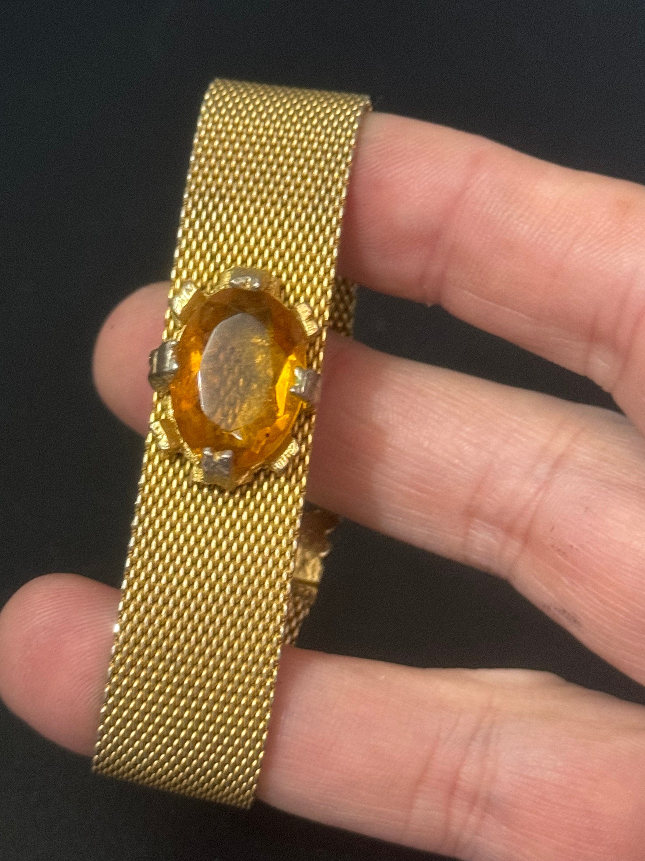 Vintage 1960s gold tone woven flat articulated Mesh bracelet with orange faux citrine cabochon 17.5cm long
