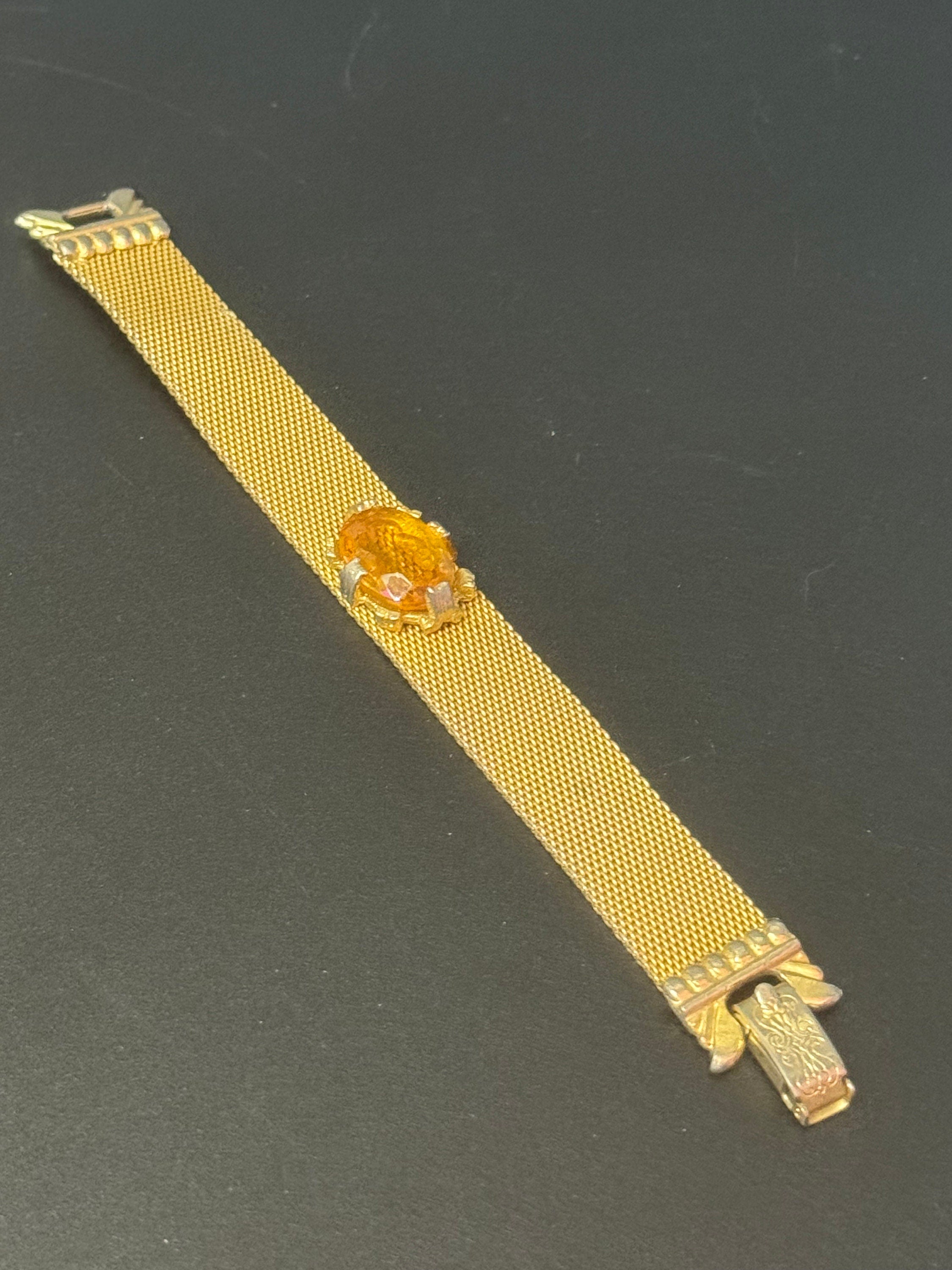 Vintage 1960s gold tone woven flat articulated Mesh bracelet with orange faux citrine cabochon 17.5cm long