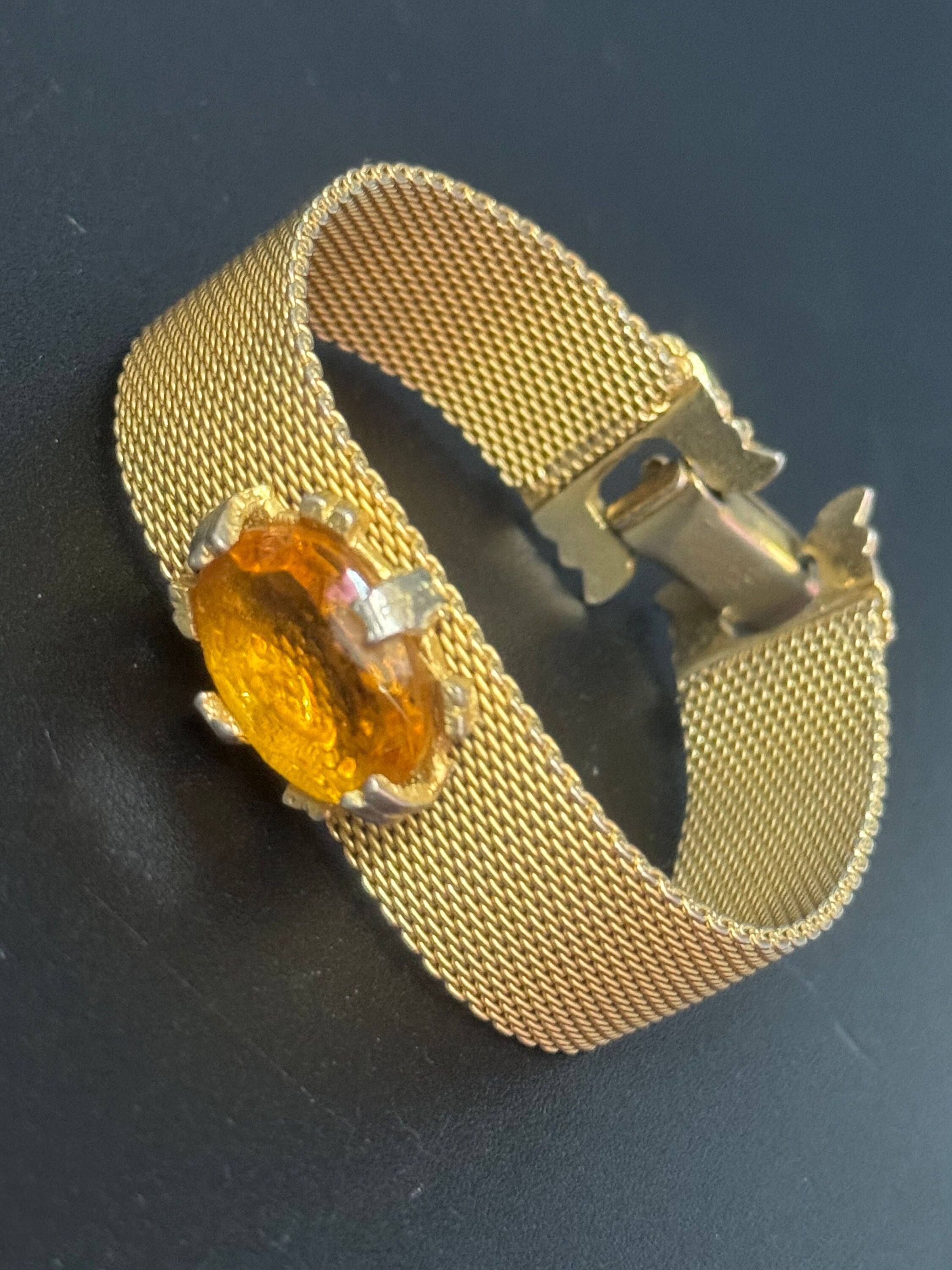 Vintage 1960s gold tone woven flat articulated Mesh bracelet with orange faux citrine cabochon 17.5cm long