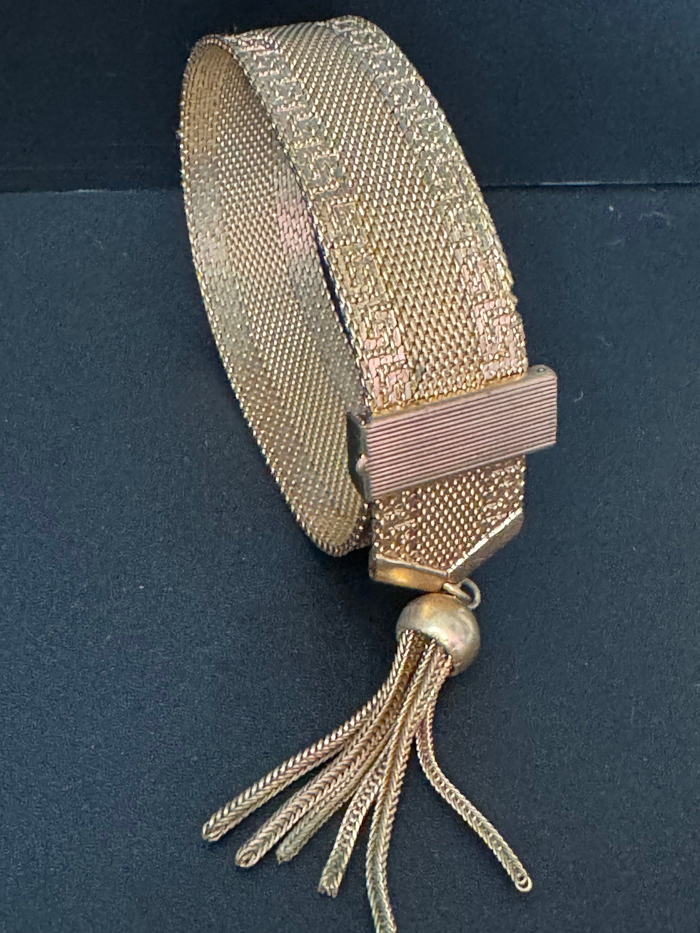 1970s Greek key design gold tone articulated flat 2cm wide tassel bracelet 19cm