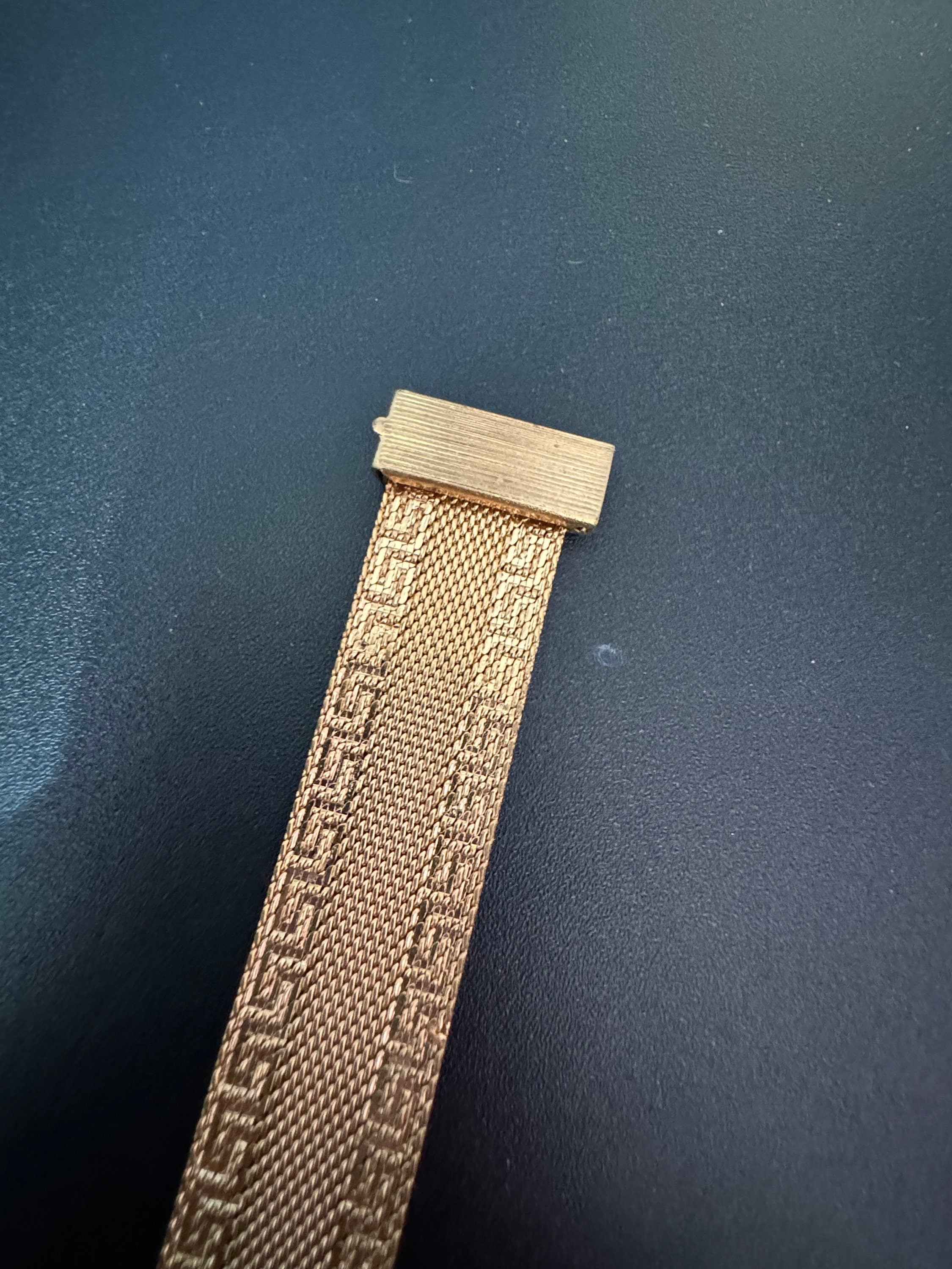 1970s Greek key design gold tone articulated flat 2cm wide tassel bracelet 19cm