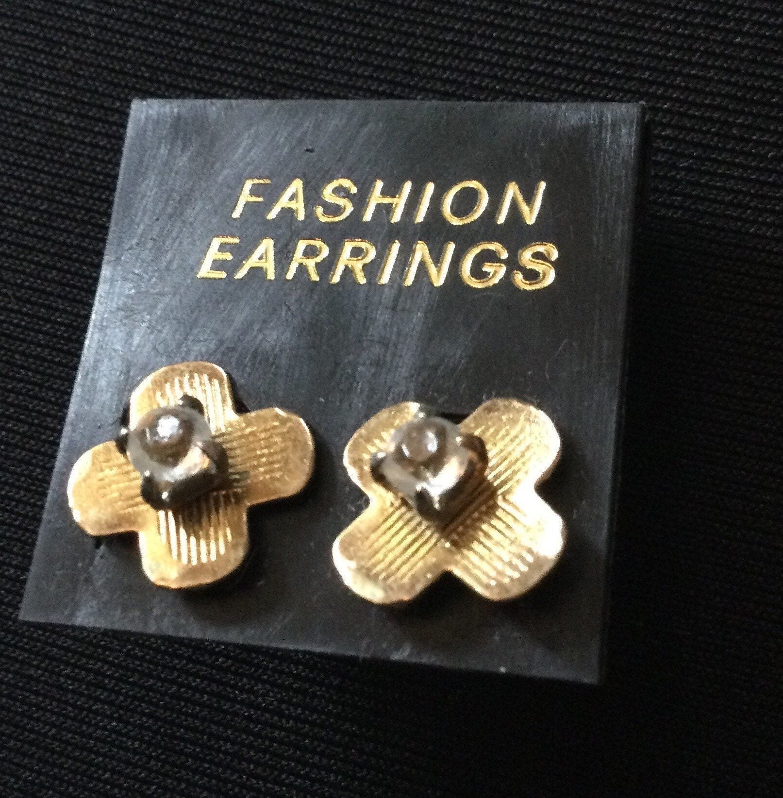 Small gold stud earrings and
