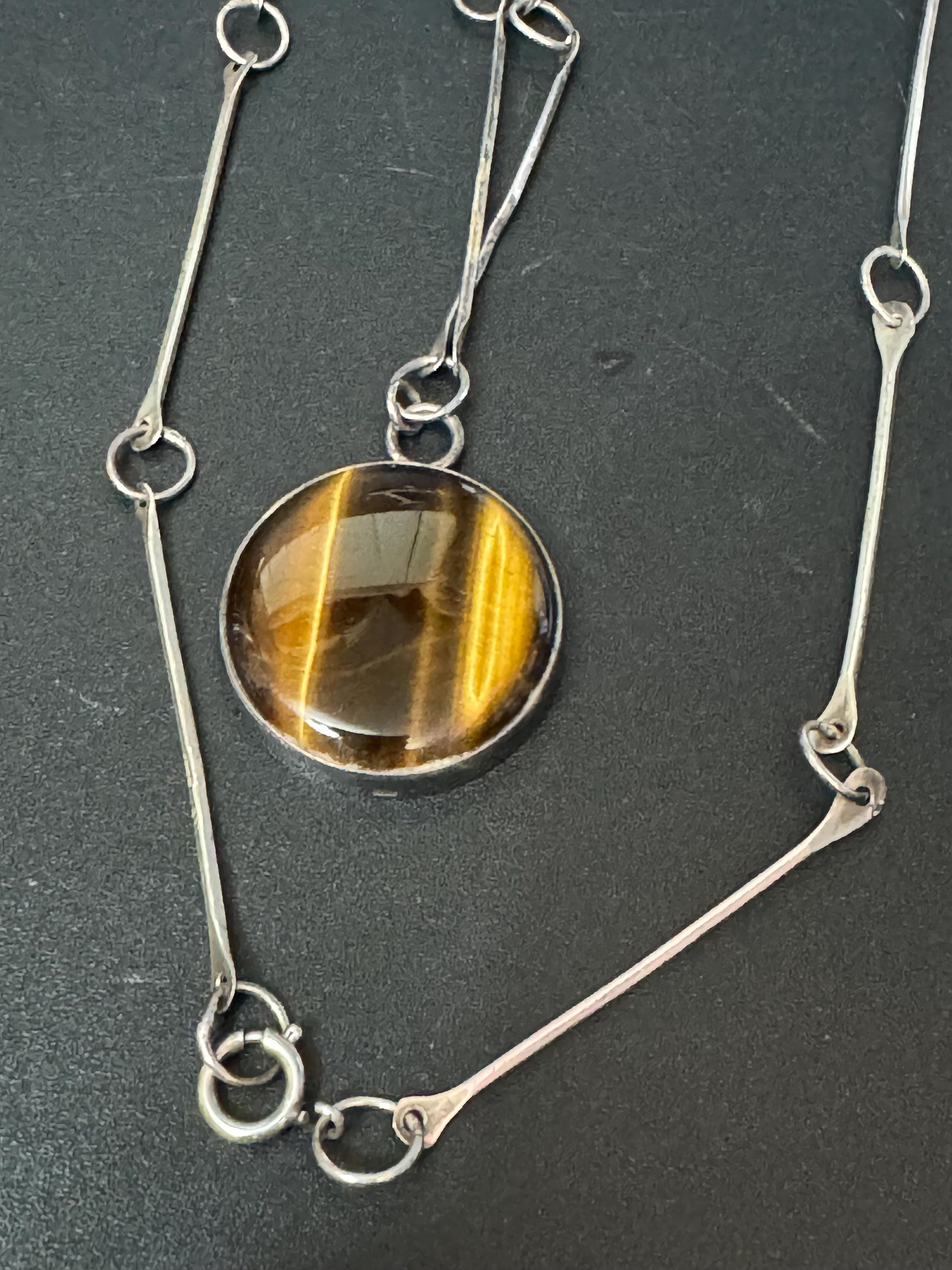 Solid silver long tigers eye round pendant necklace on 75cm chain 917 grade Naples or Malta 1970s weighs 25.5 grams